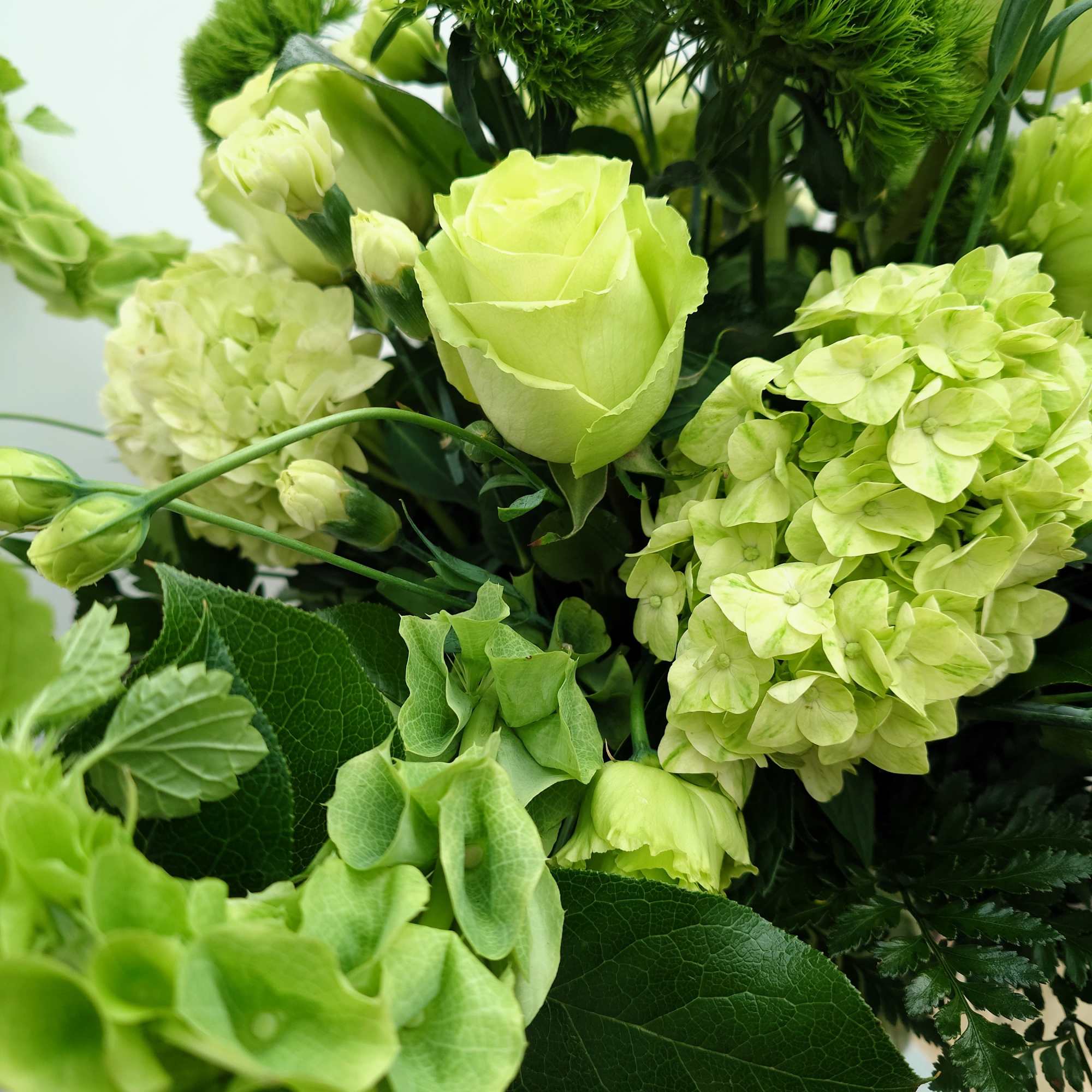 Lush, fresh, monochrome with premium blooms in shades of green.