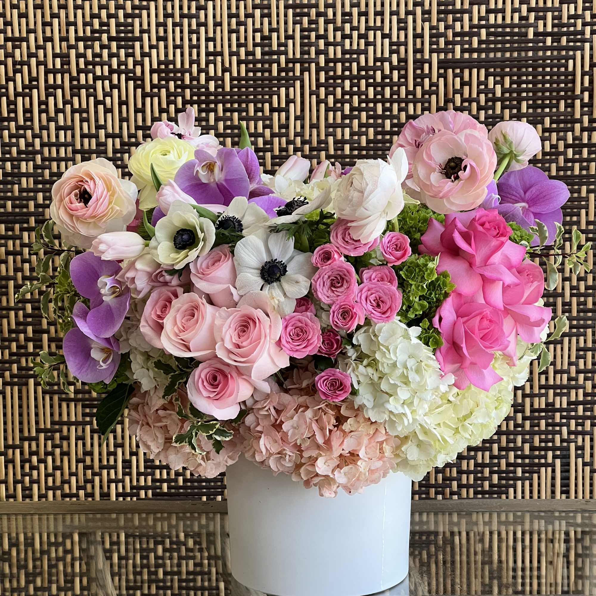 A simple, sweet arrangement of Roses, Spray Roses, Anemones, Tulips, Ranunculus and