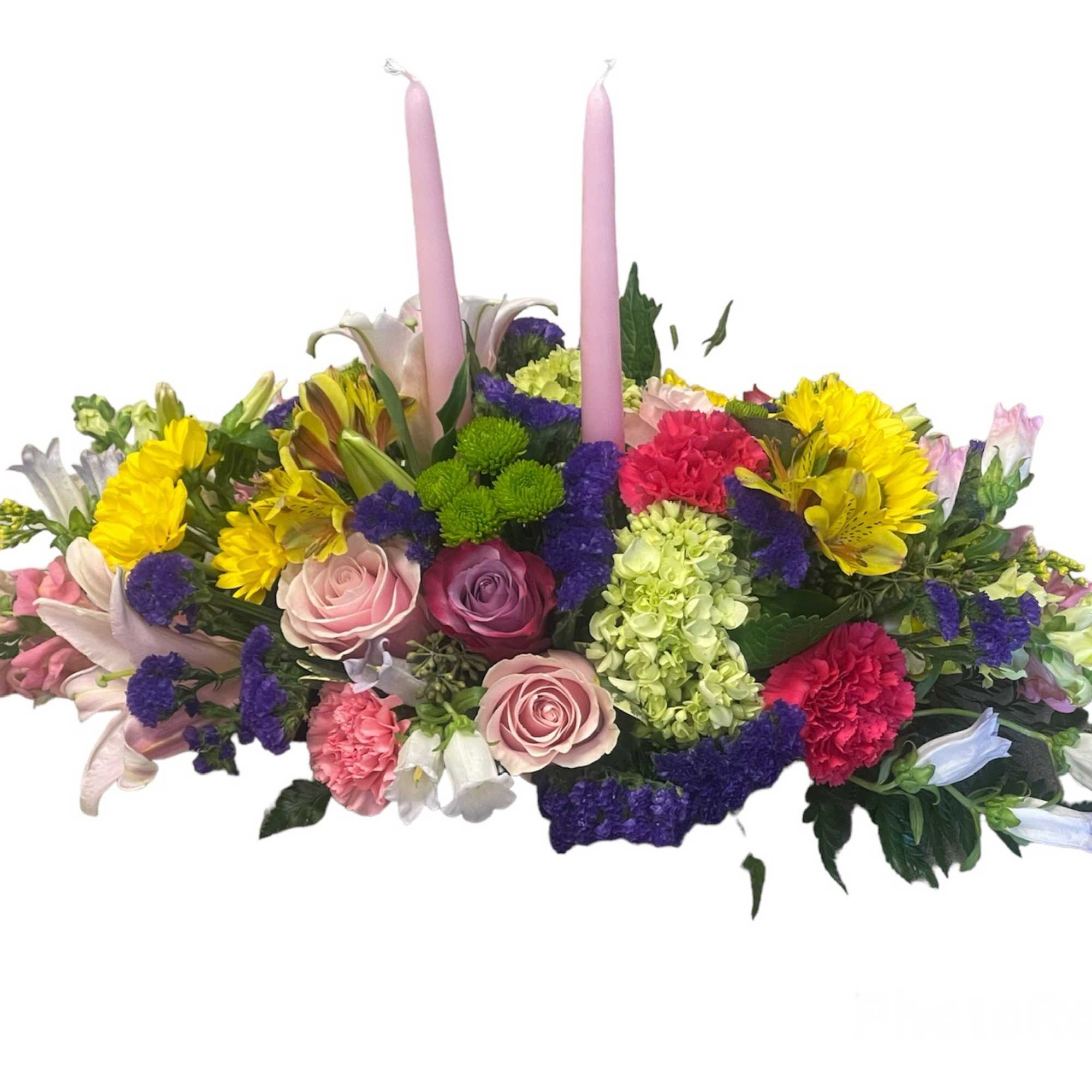 A mixture of spring color flowers in a low container accented with
