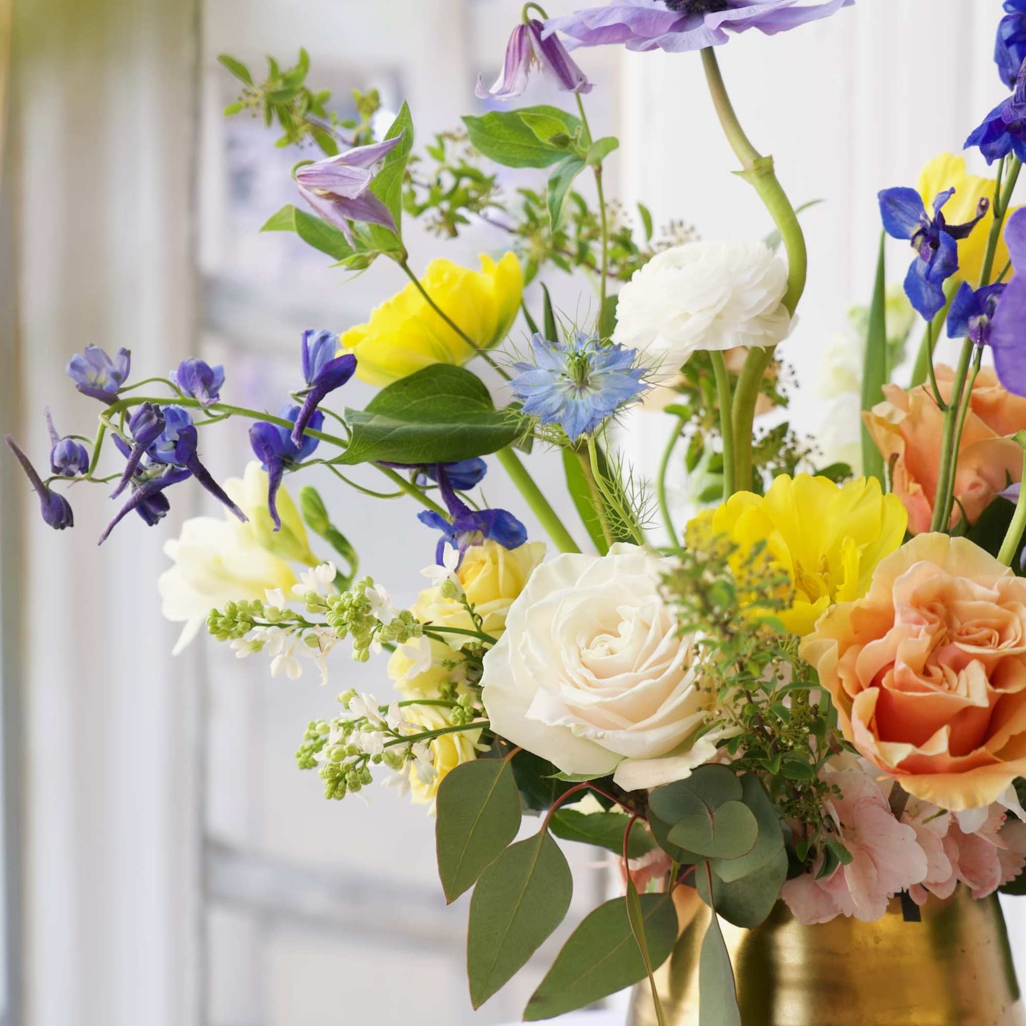 A dreamy blend of delphinium, anemones, roses, and ranunculus&mdash;soft hues and bright