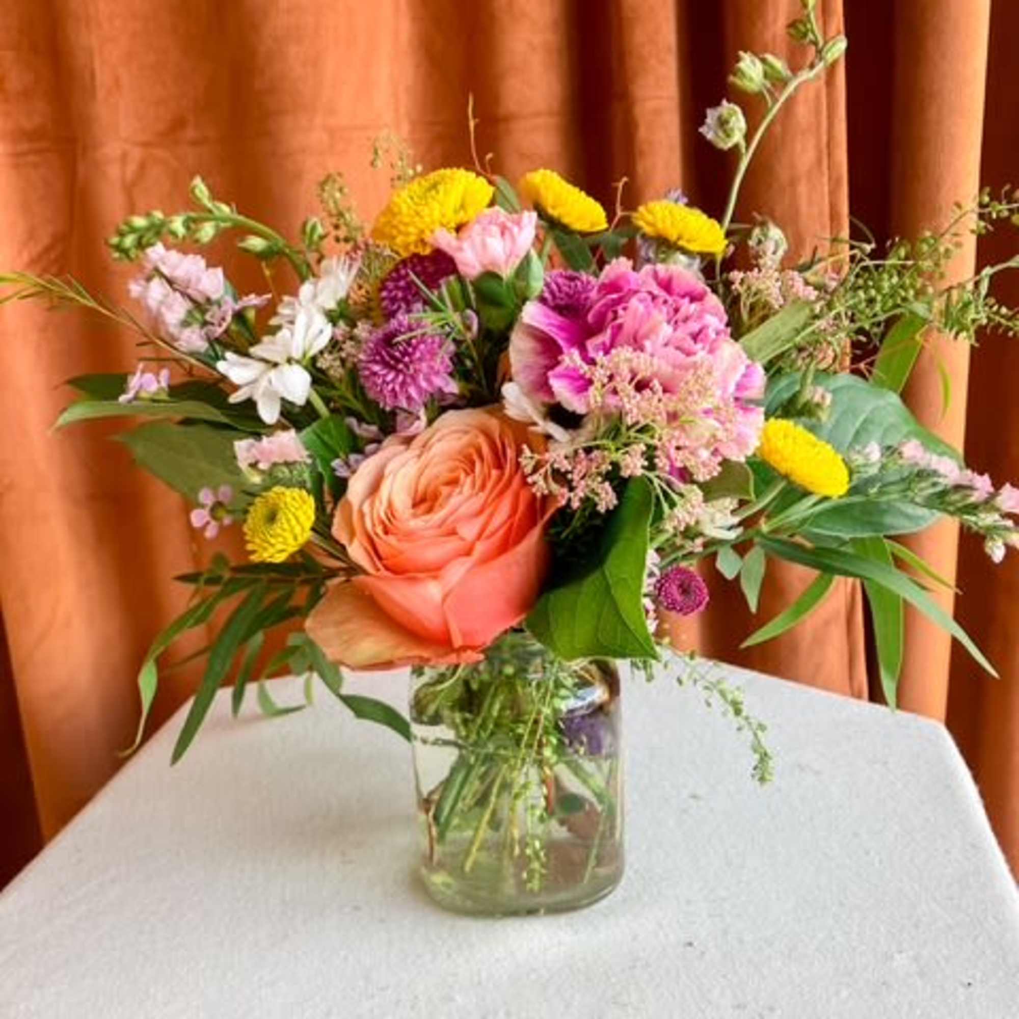 First Bloom is a designer's choice arrangement that captures the untamed beauty