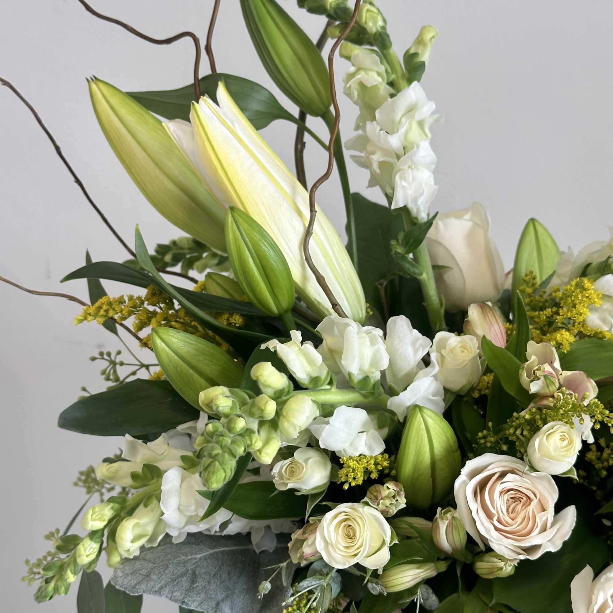 The Always Adored sympathy flower arrangement is a serene, all-white tribute designed