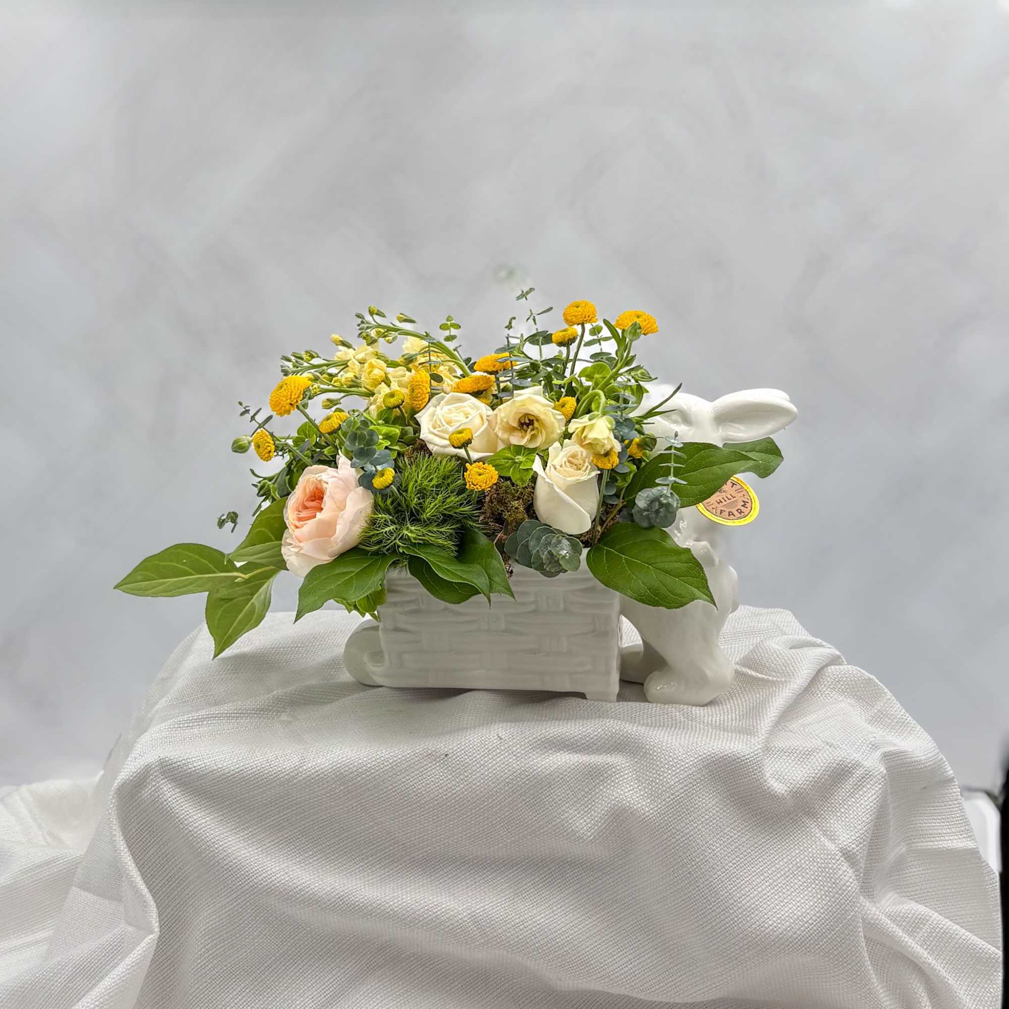 Spring blooms in an adorable Easter Bunny with wagon ceramic keepsake container.