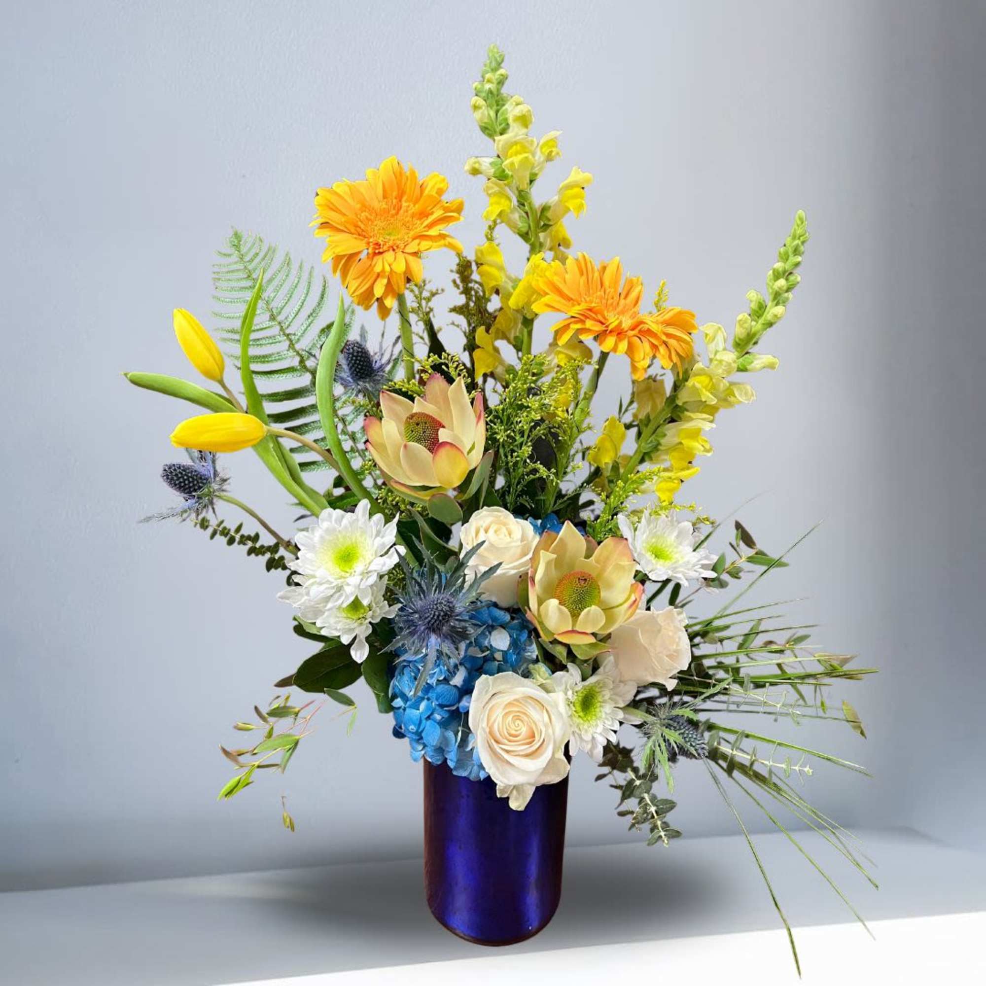 Recipe: Yellow Snapdragons, White Roses, Yellow Tulips, Orange Gerbera Daisies, Leucadendron Conebush