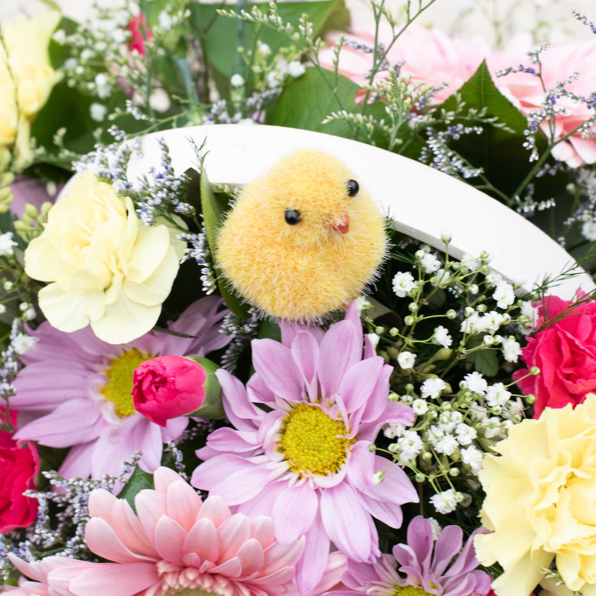 Pretty and bright white colored basket   filled with colorful spring