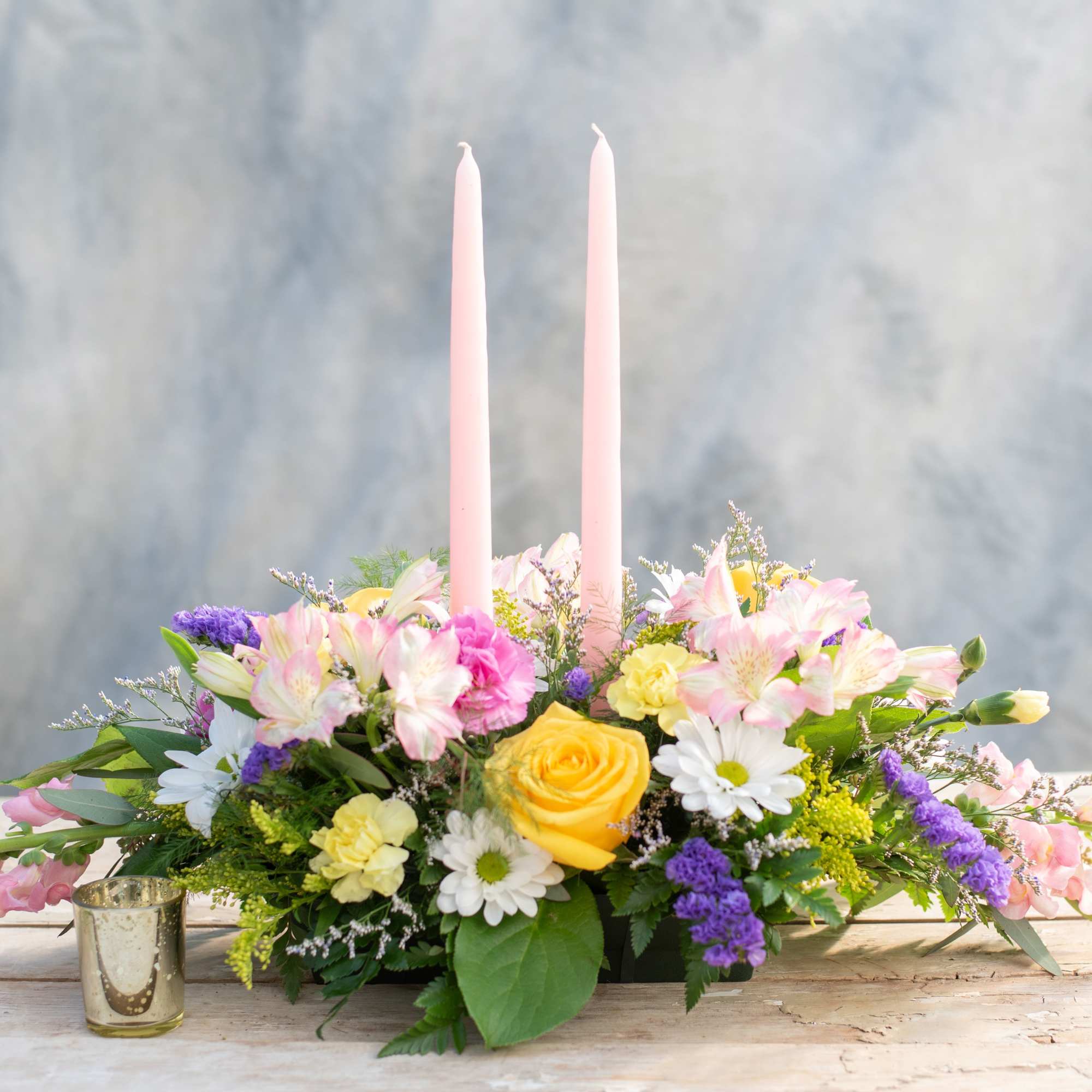 Lovely long and low centerpiece topped with two taper candles. Perfect for