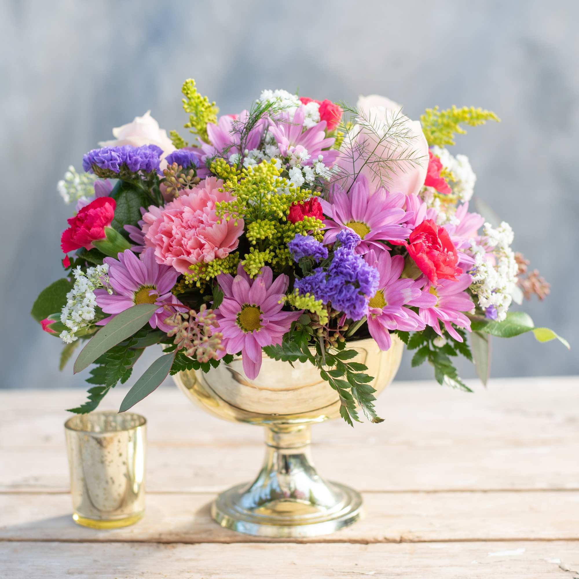 Classic rounded holiday centerpiece filled with  mums, carnatons, and more. Perfect