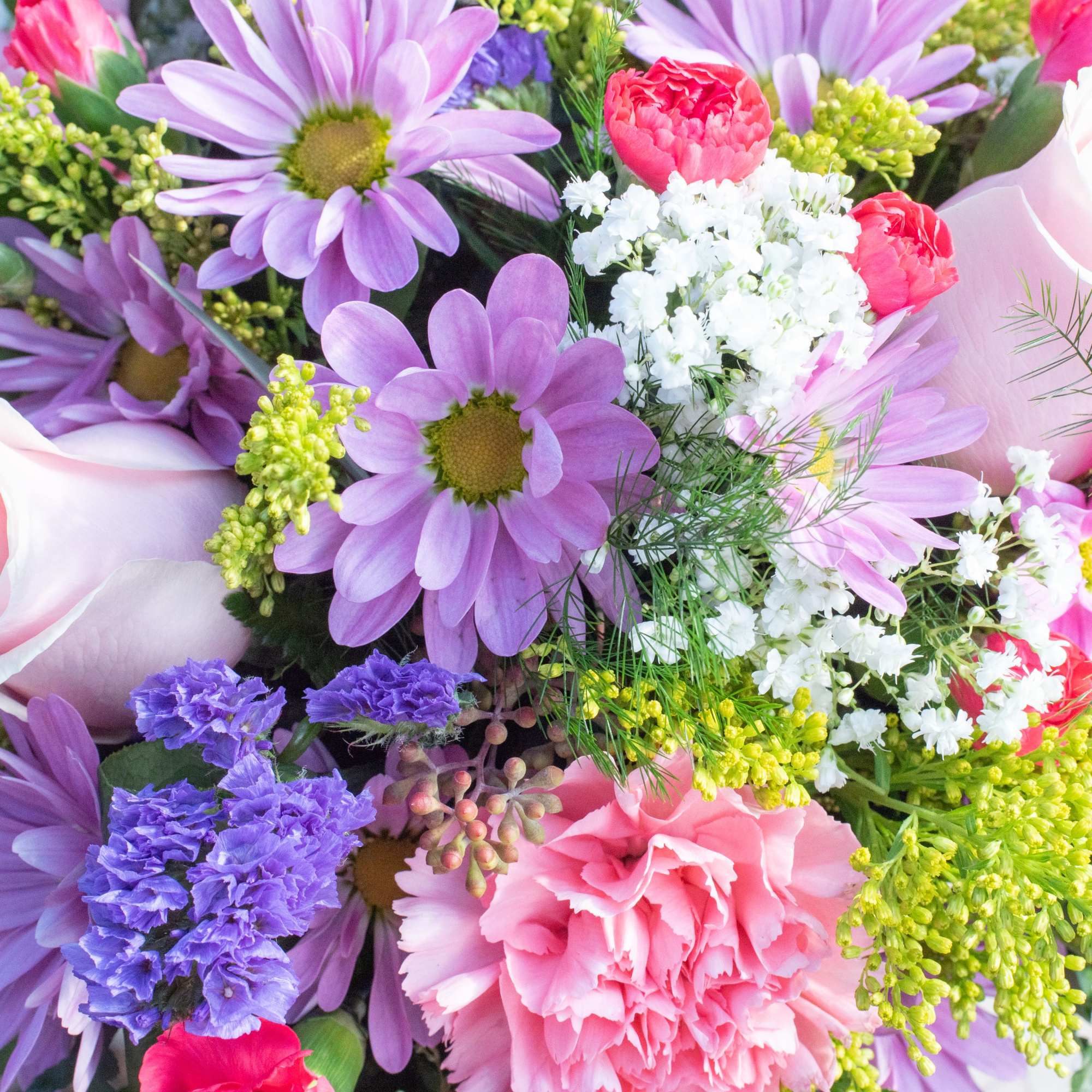 Classic rounded holiday centerpiece filled with  mums, carnatons, and more. Perfect