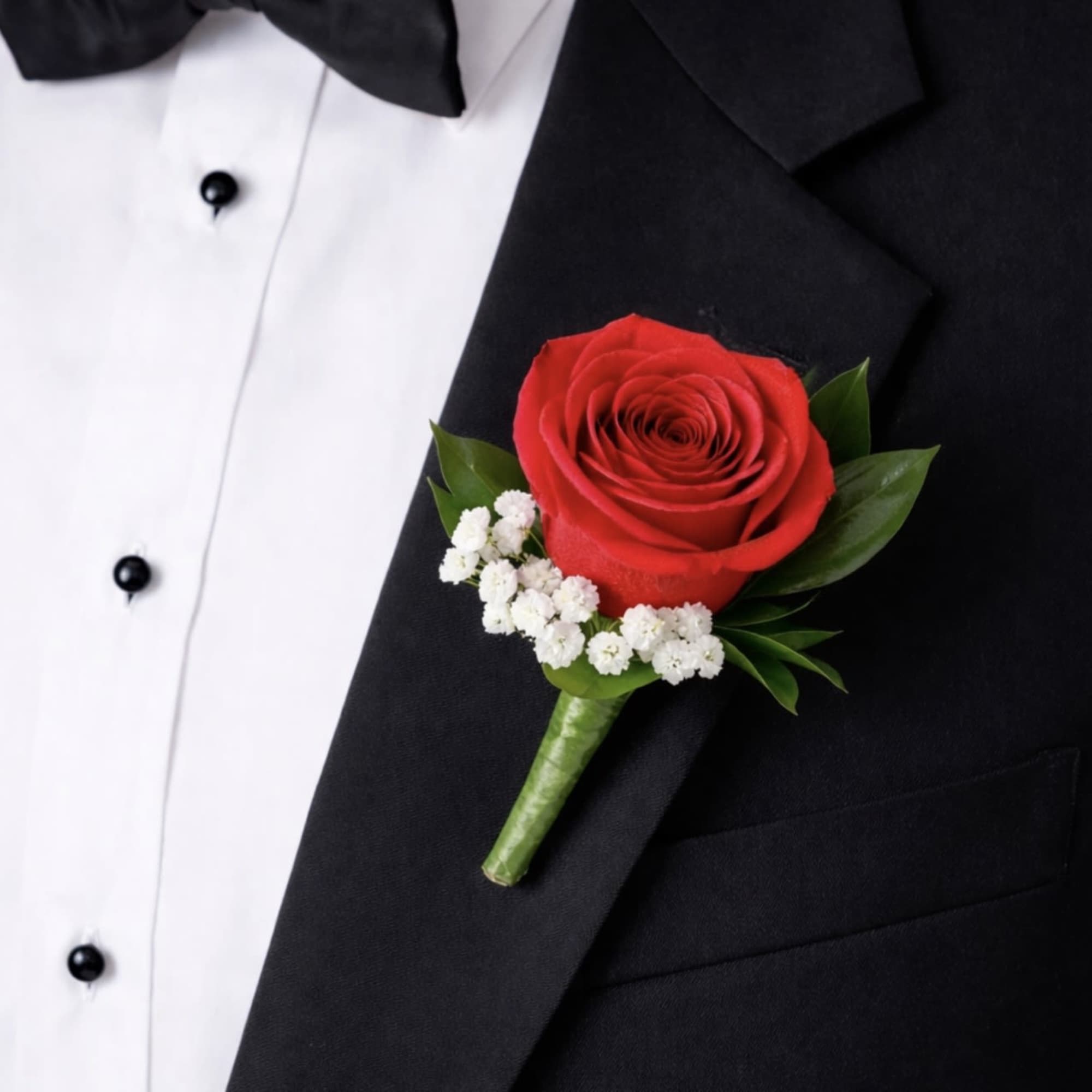 This red rose boutonniere is a timeless lapel accessory featuring a single