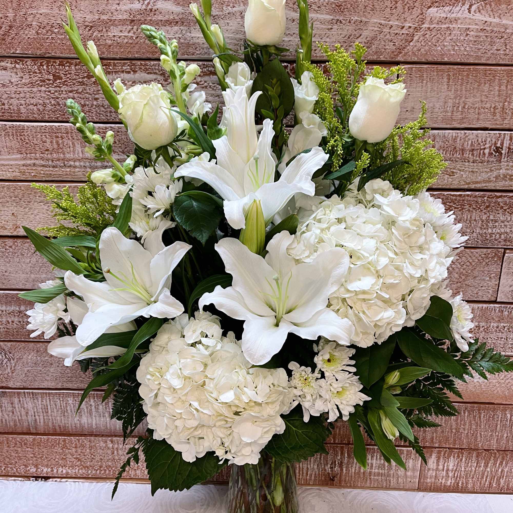 This lovely vase holds a mixture of flowers that will surely bring