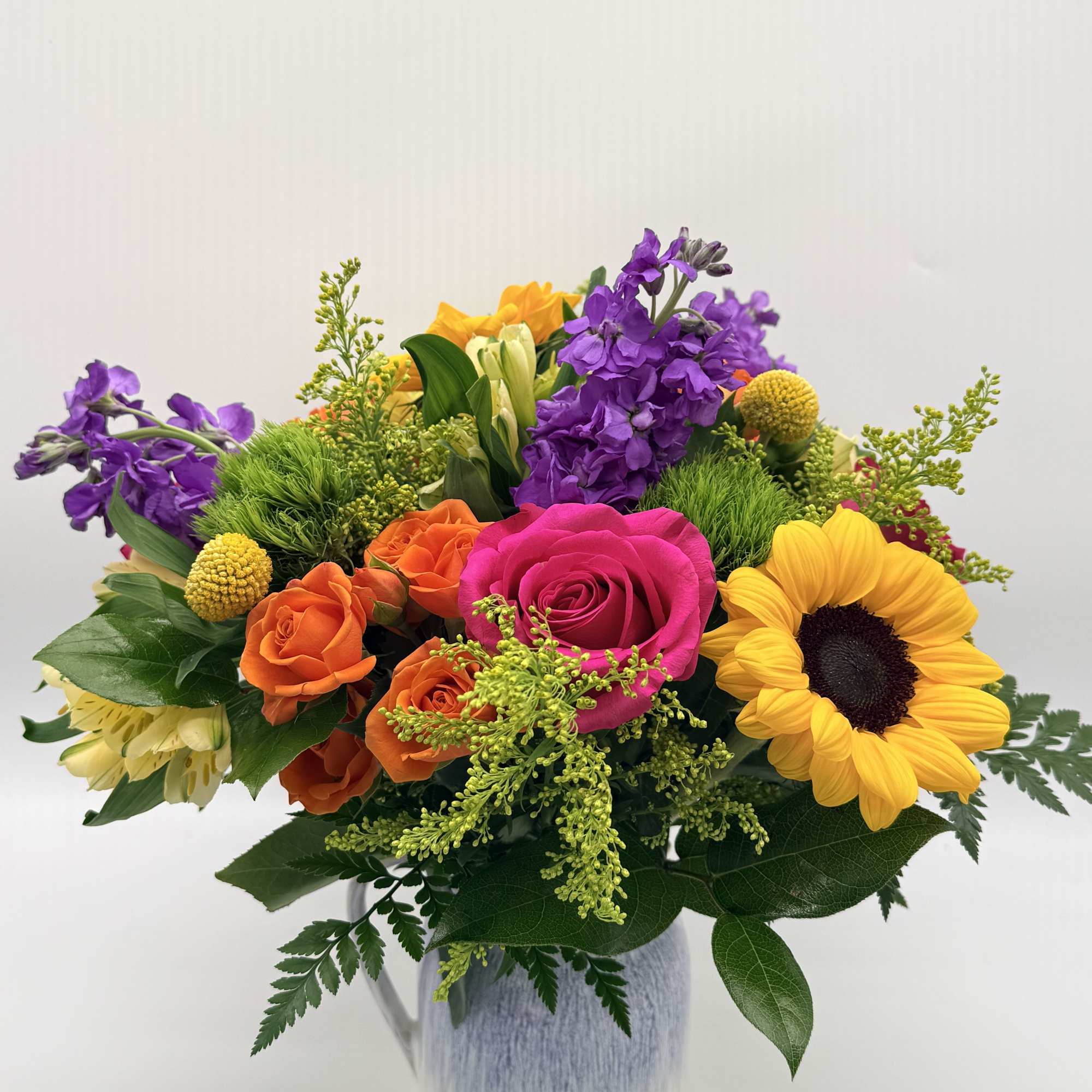 Bright, cheerful, and full of charm, this vibrant arrangement is beautifully designed