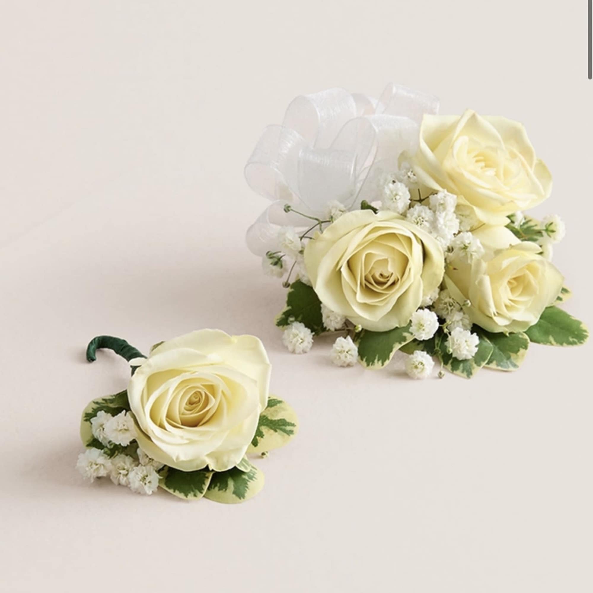 This elegant corsage and boutonniere set is thoughtfully designed to pair perfectly