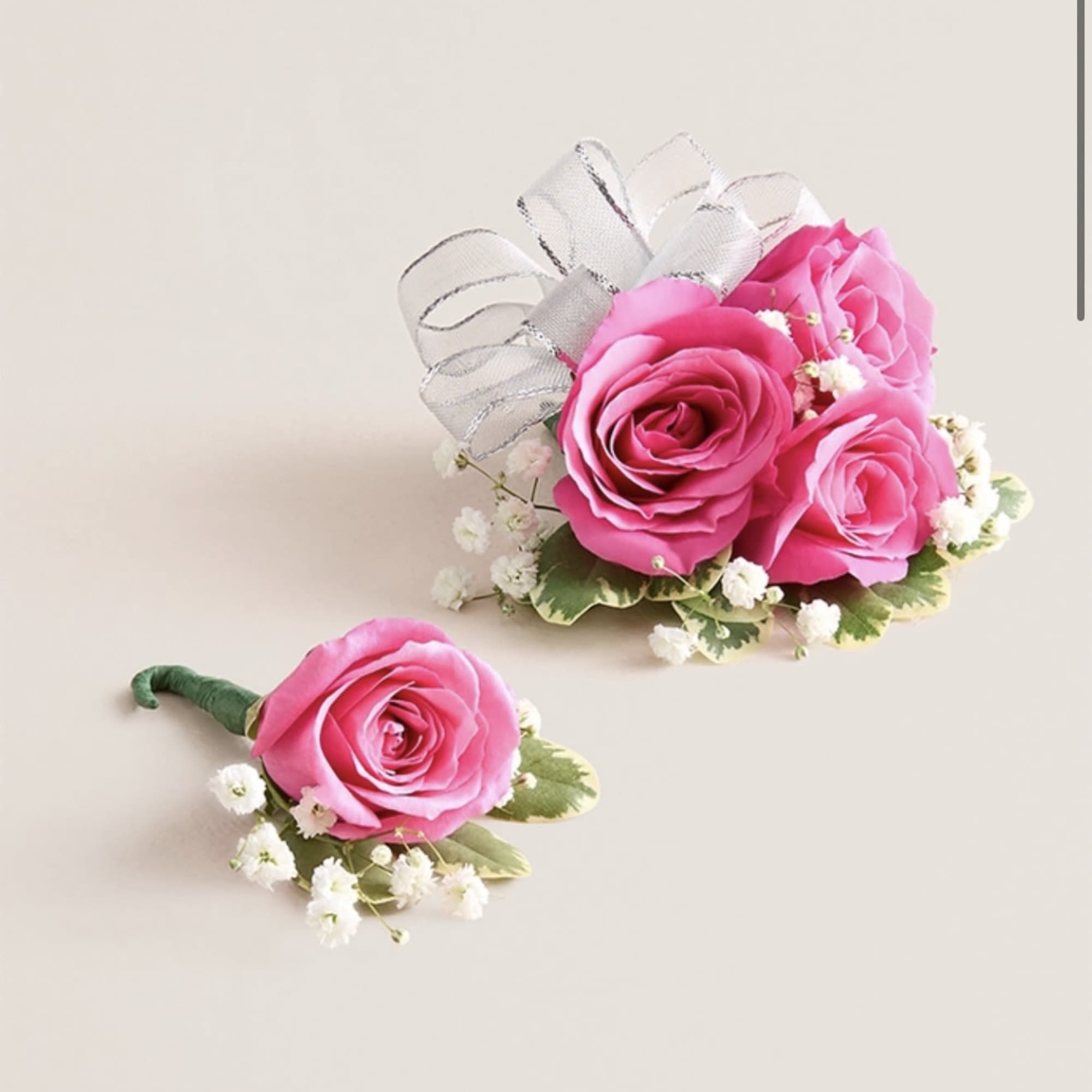 This striking corsage and boutonniere set, featuring bold hot pink blooms, is