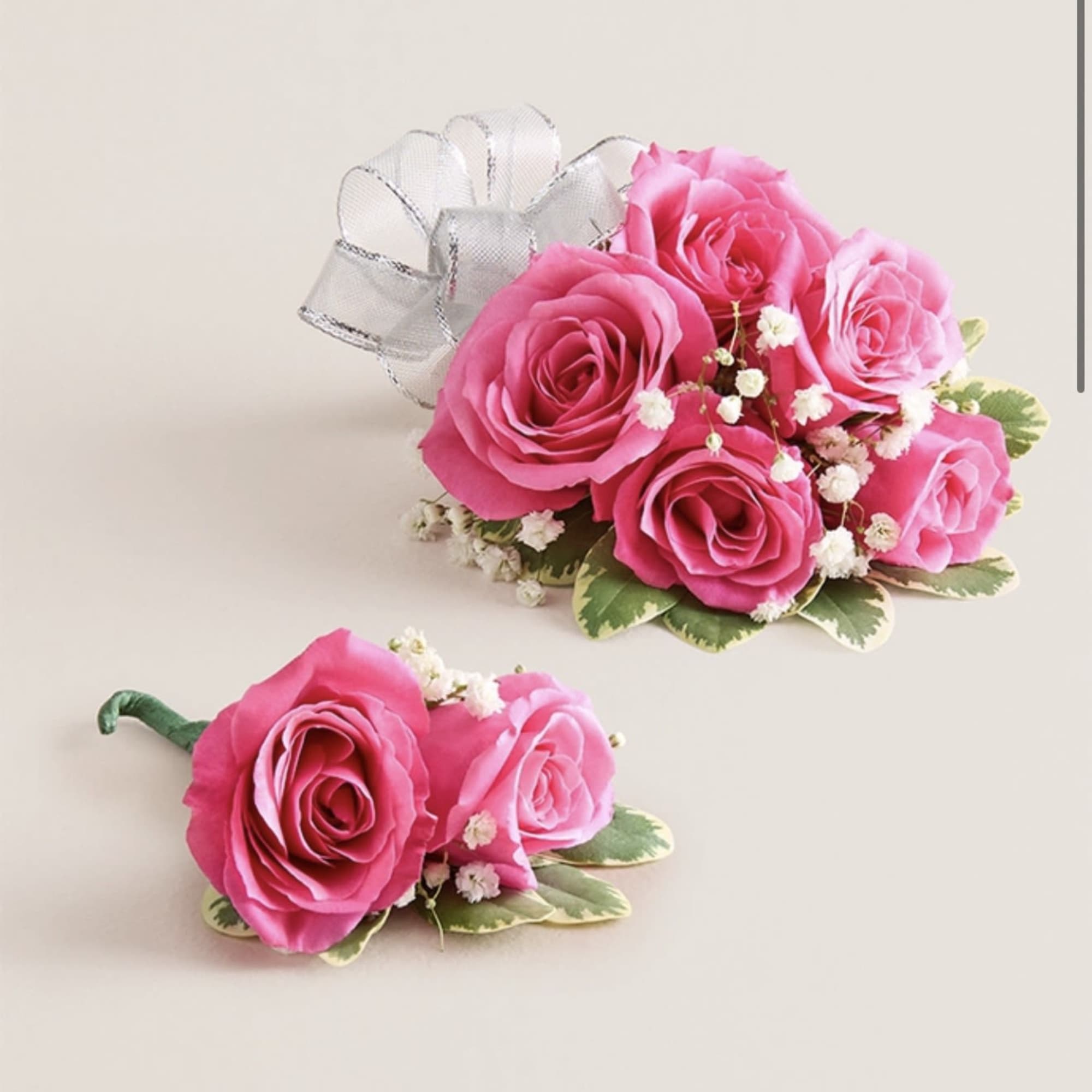 This striking corsage and boutonniere set, featuring bold hot pink blooms, is