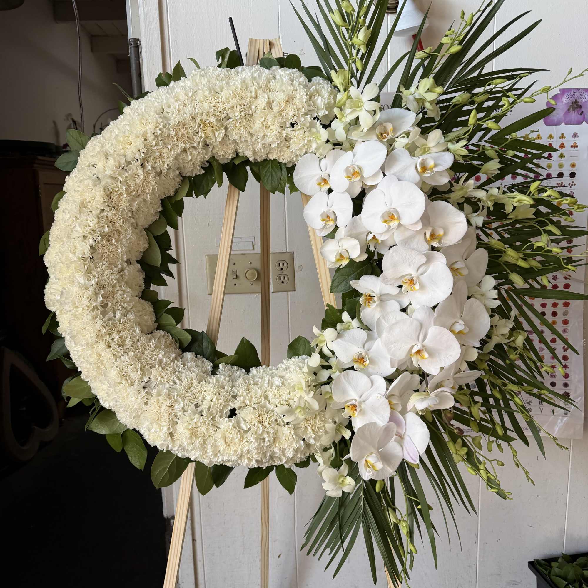 24 Inch Wreath with white orchids , carnations, and gladiolus 