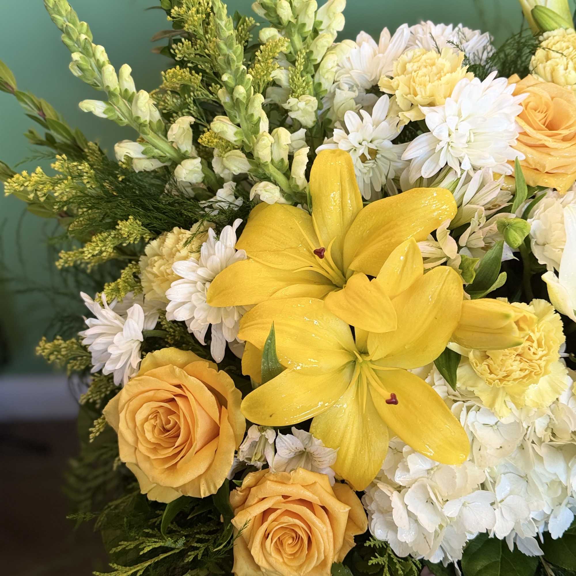 A woven basket overflows with a cheerful arrangement of yellow and white