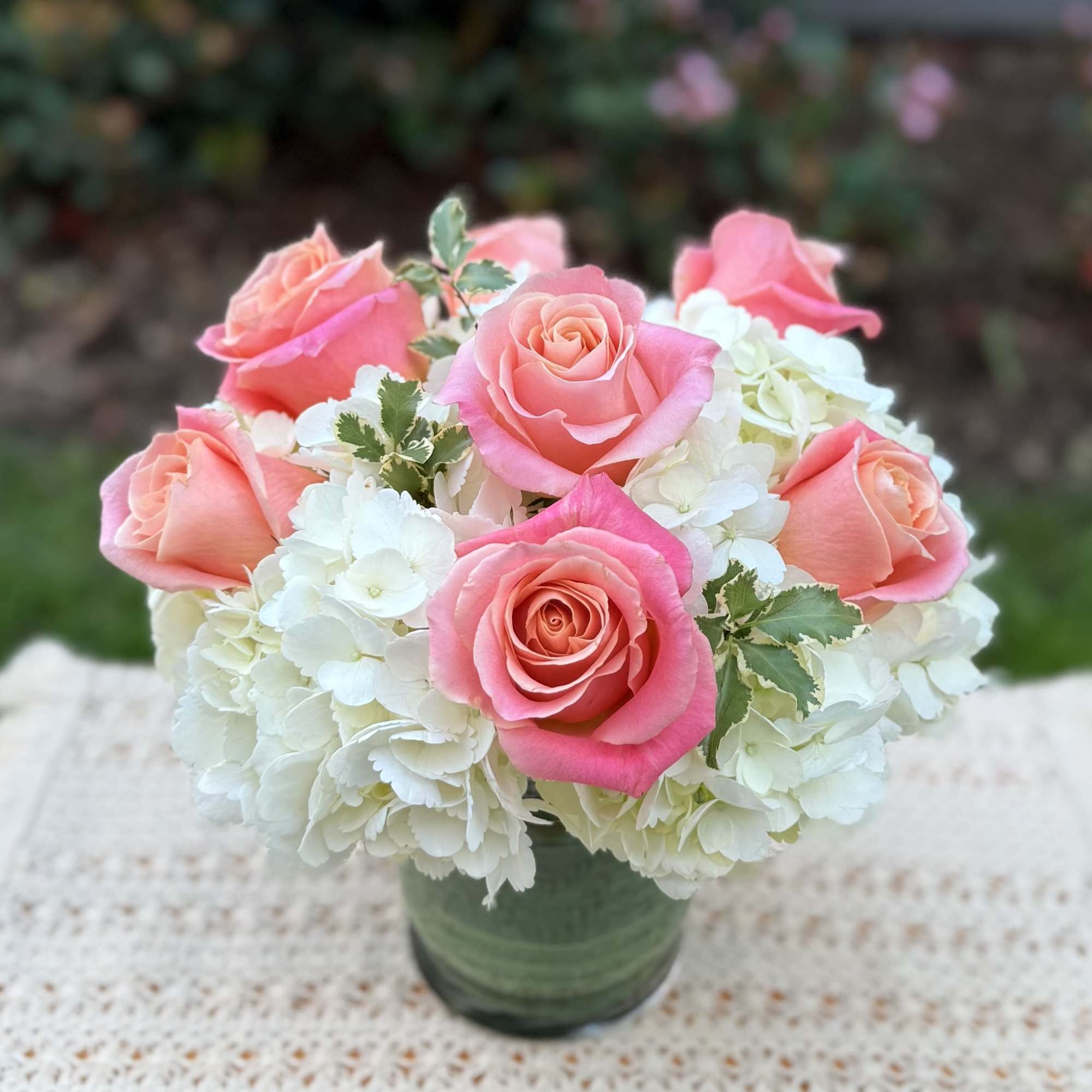 Beautiful Classic arrangenment crafted with beautiful hydrangeas and Ecuadorian roses, accented with