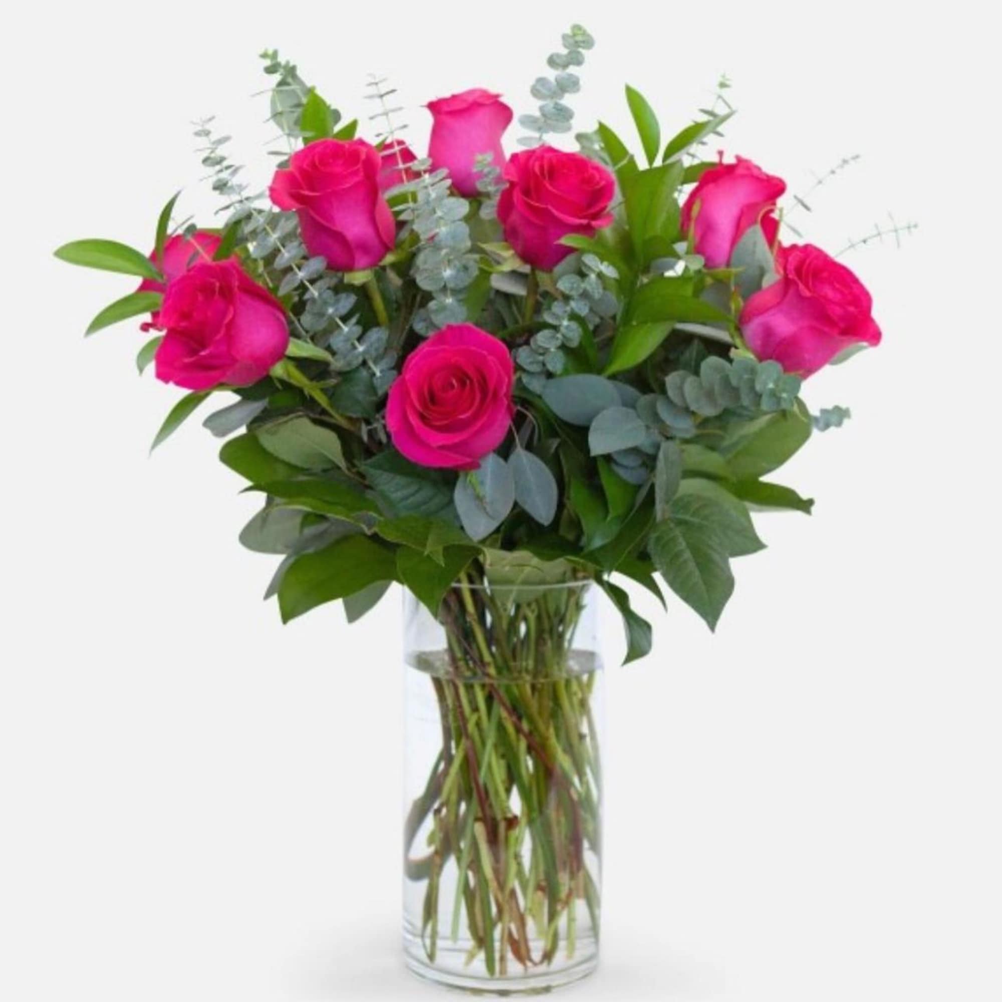 Lucious dozen of hot pinks in a vase topped with eucalyptus 