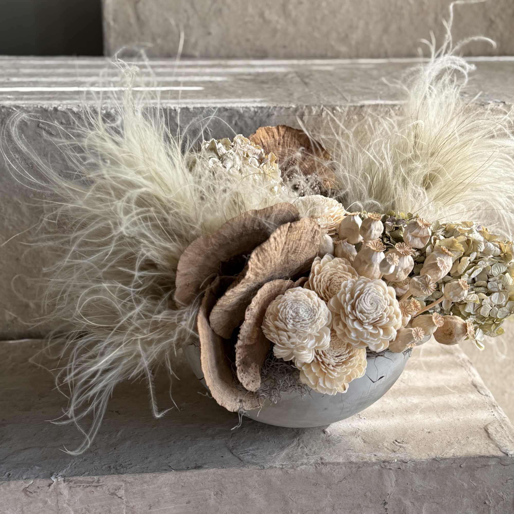 Set in a minimalist, stone-textured ceramic bowl, it features a blend of
