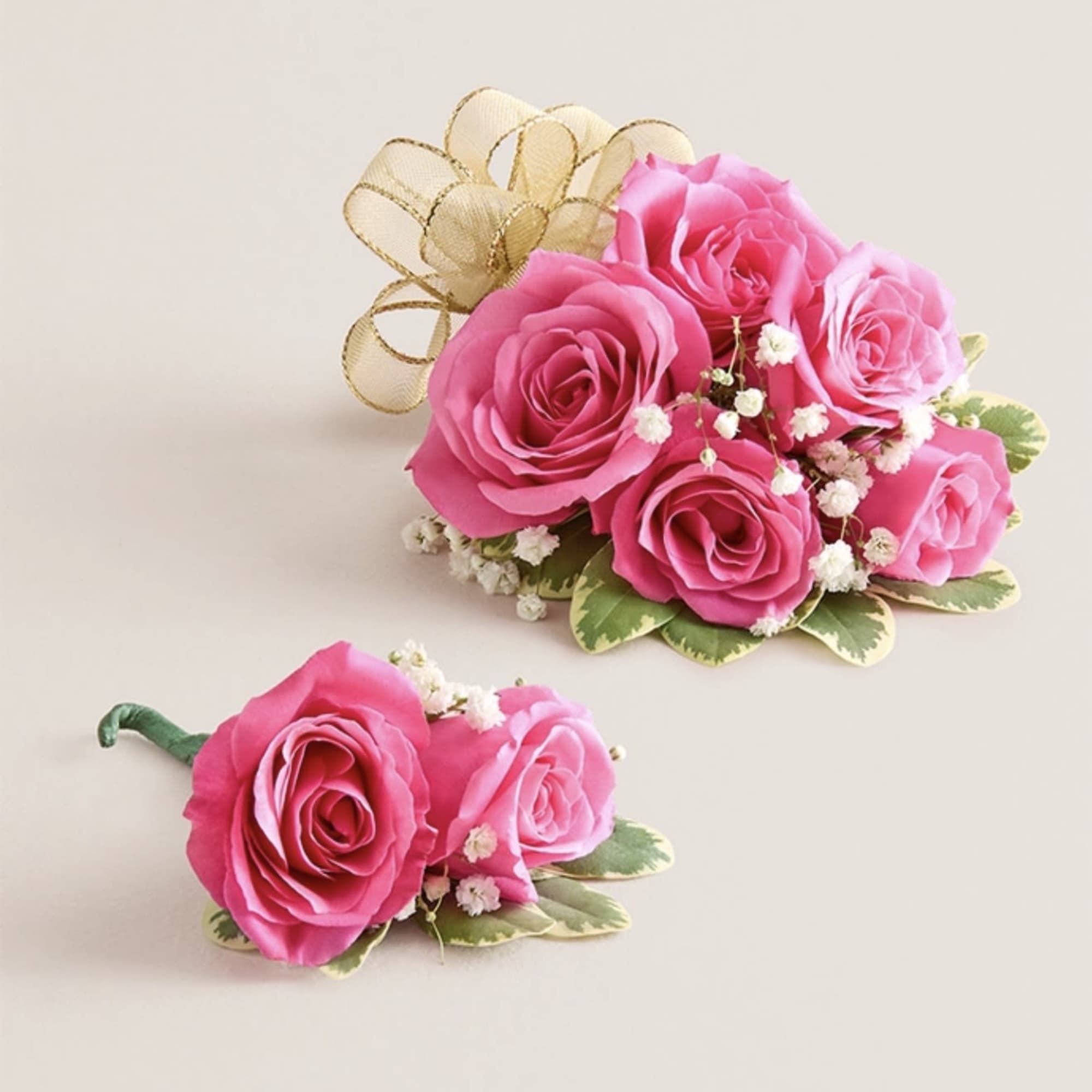 This striking corsage and boutonniere set, featuring bold hot pink blooms, is