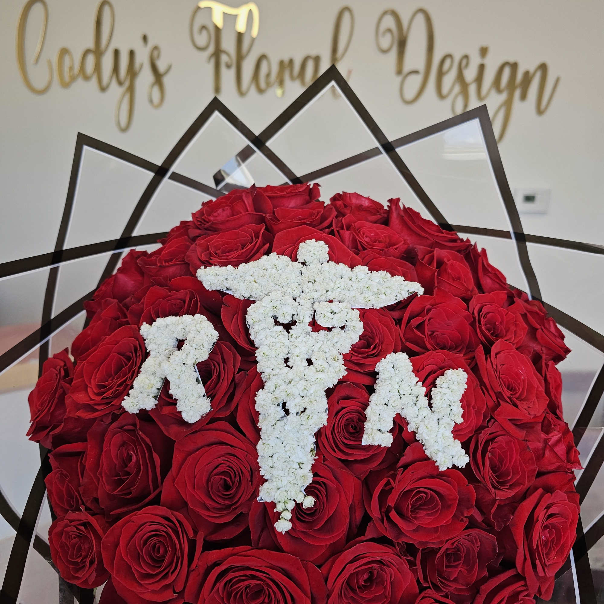 Our 25/50/75 Stem Rose Bouquet with baby's breath logo/initials delivers elegance, romance