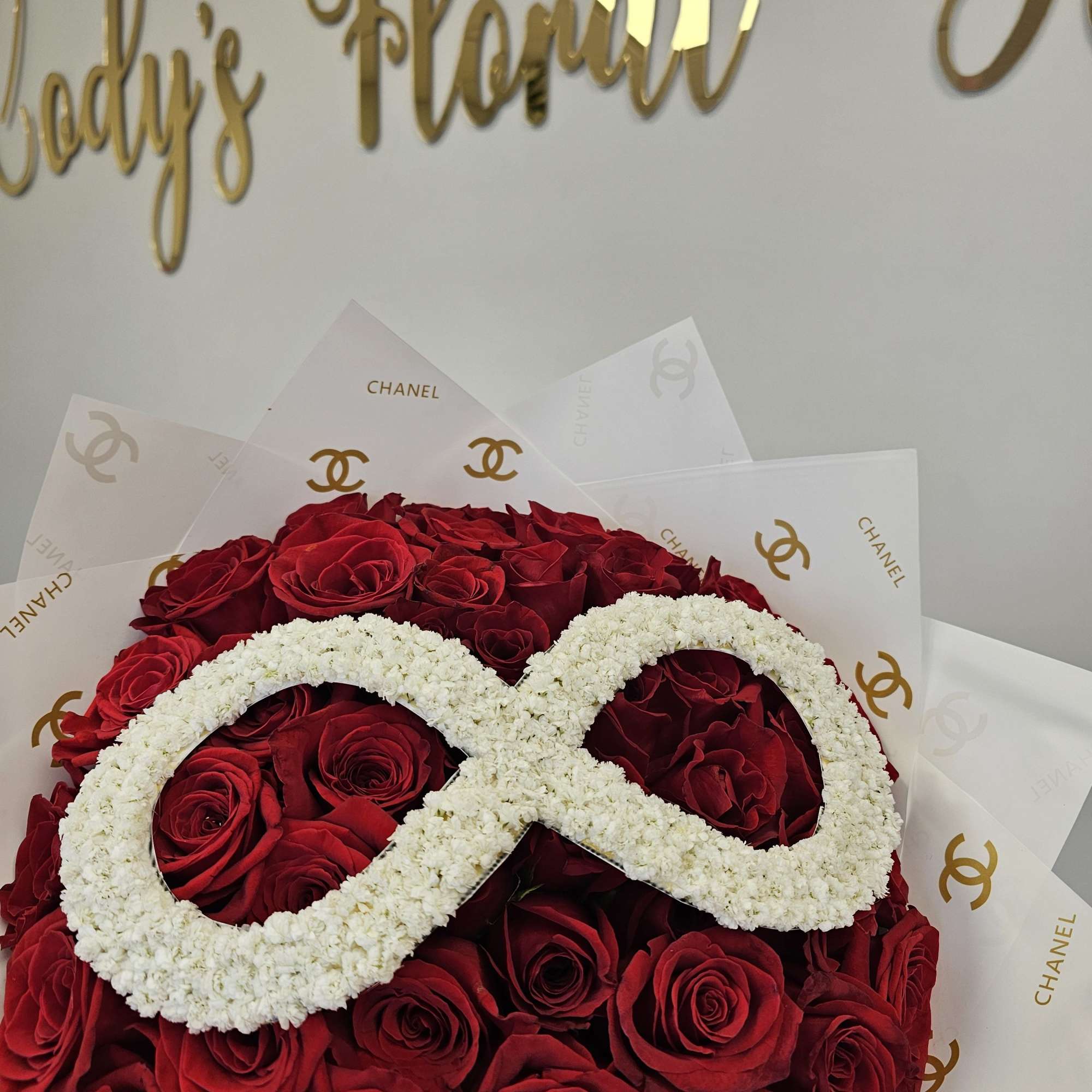 Our 25/50/75 Stem Rose Bouquet with baby's breath logo/initials delivers elegance, romance