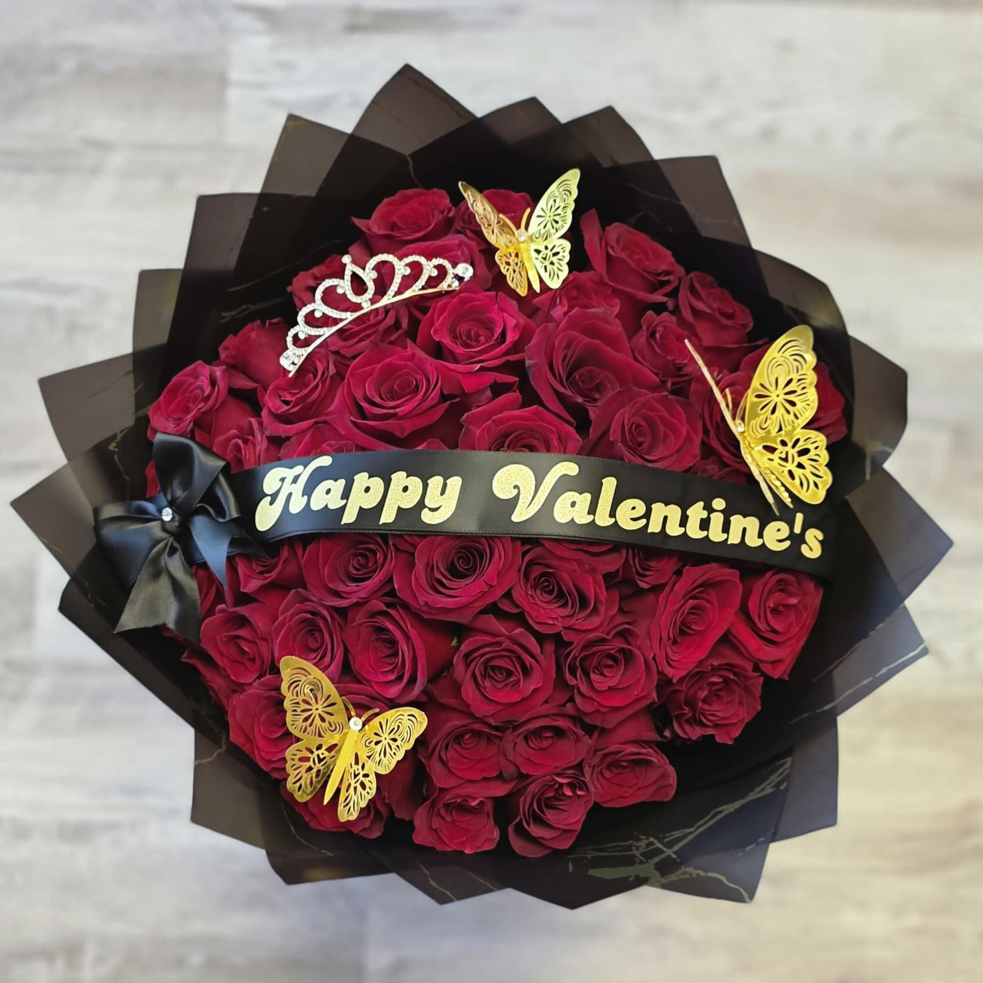 Our 25/50/75 Stem Rose Bouquet with custom banner, crown and butterflies delivers