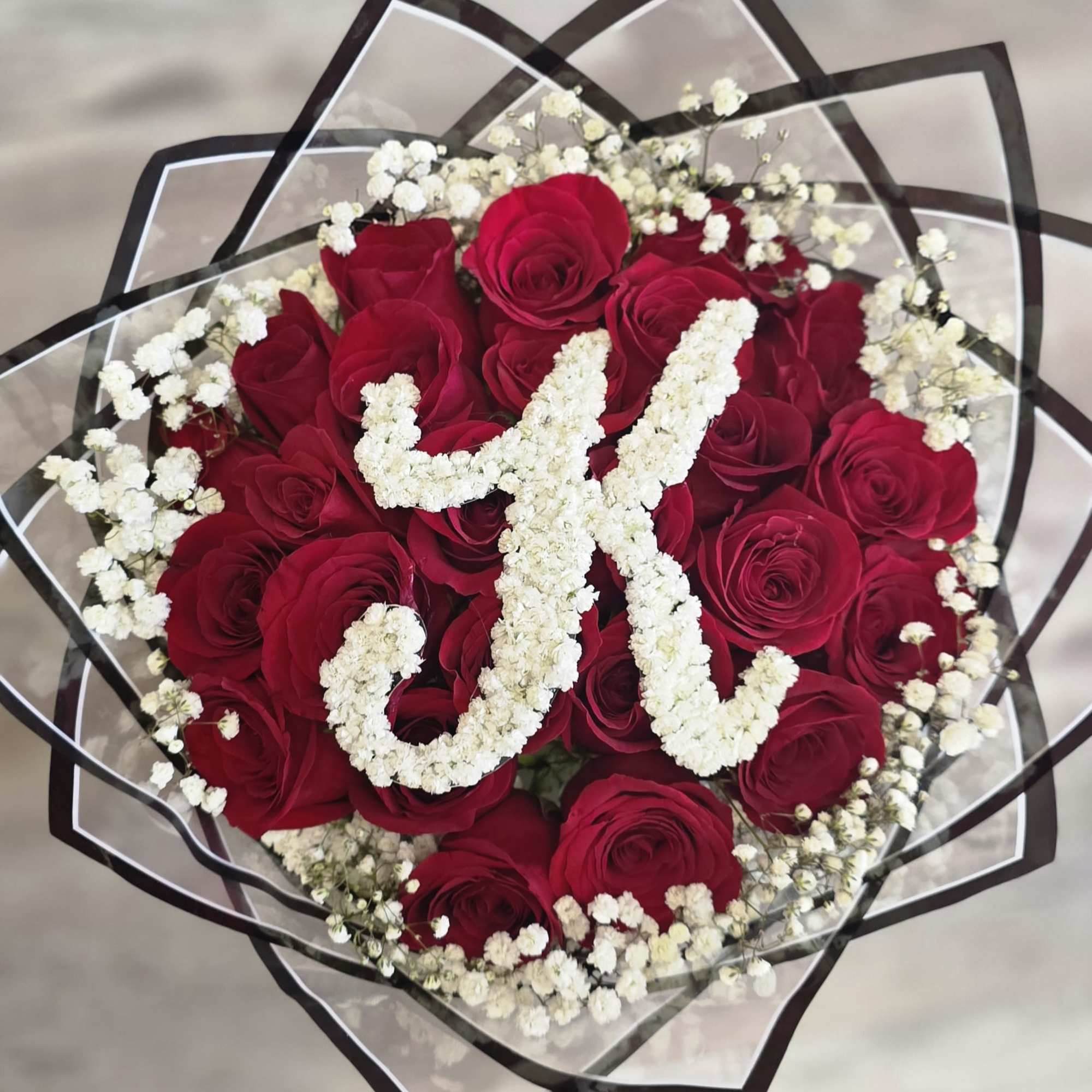 Our 25/50/75 Stem Rose Bouquet with custom baby's breath initial and baby's