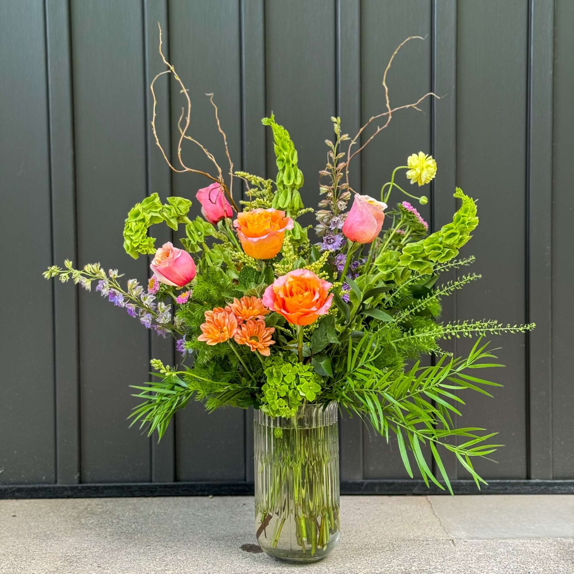 A bright palette of our freshest flowers in a large dramatic presentation.
