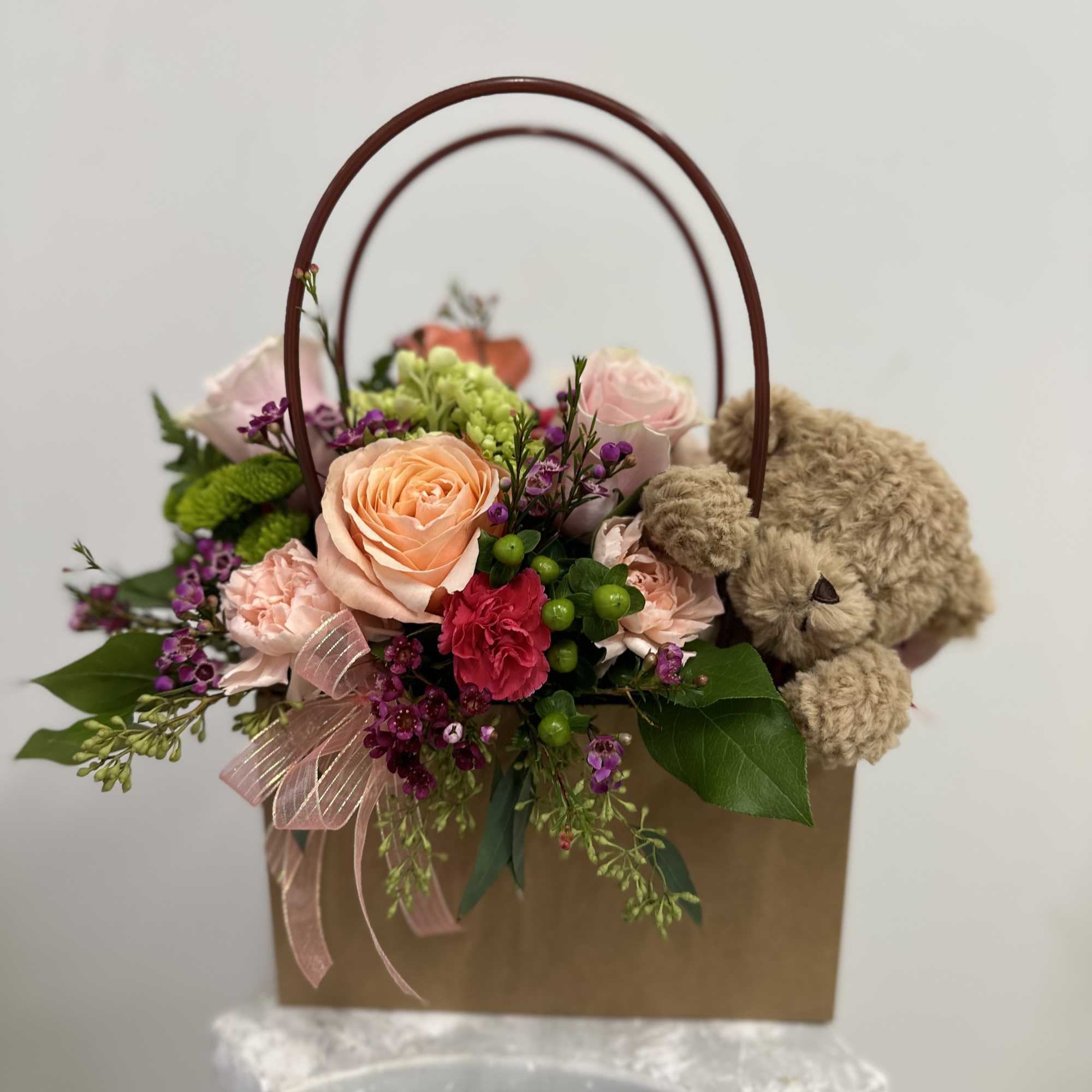 Surprise your loved ones with our adorable Flower Gift Bag arrangement with