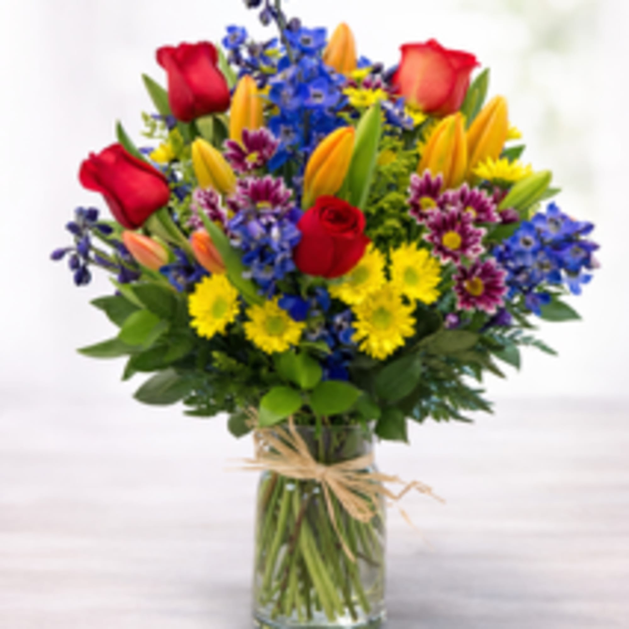Check out this colorful floral with Deep blues, orange and other flowers.