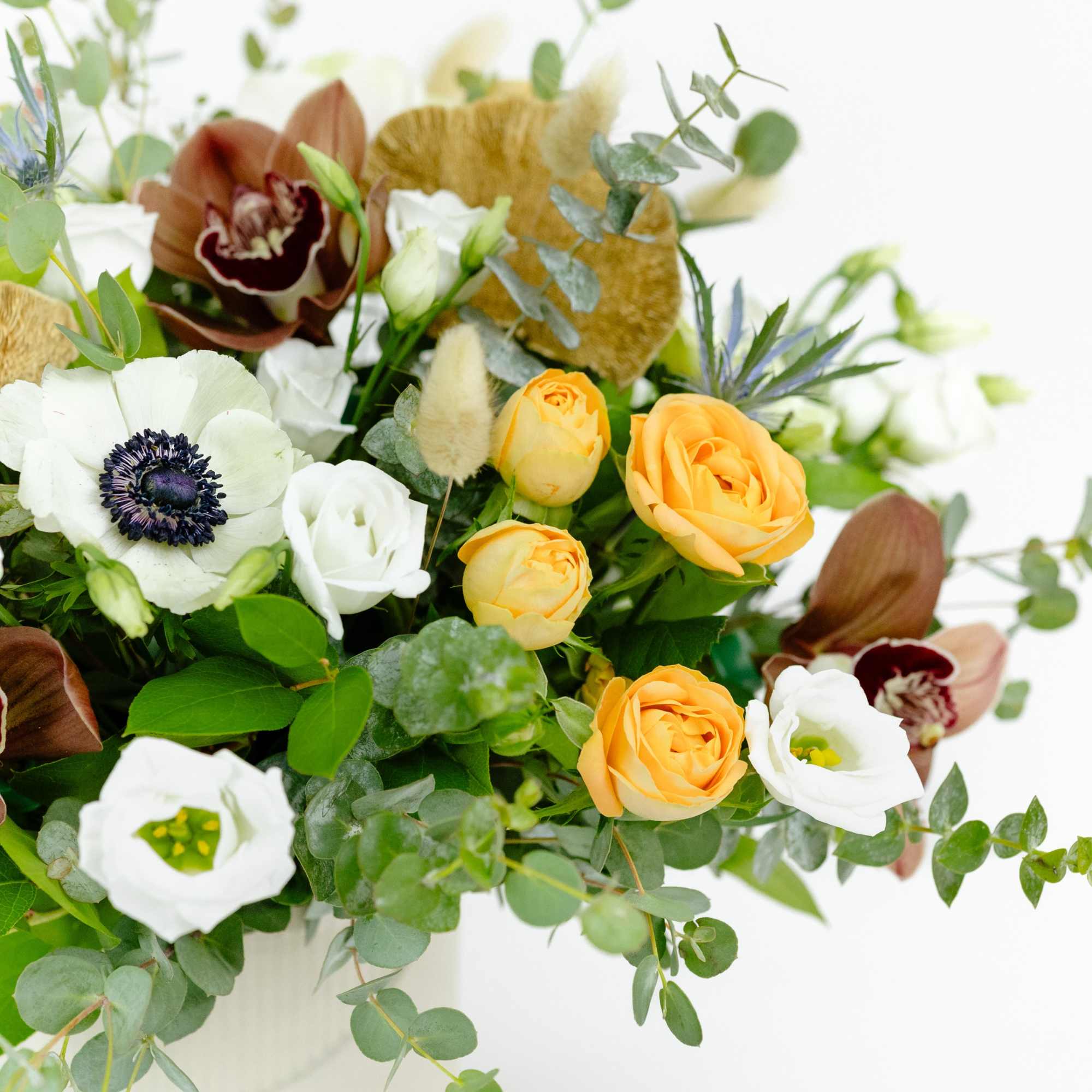 Bouquet of white and yellow flowers with eucalyptus in a vase