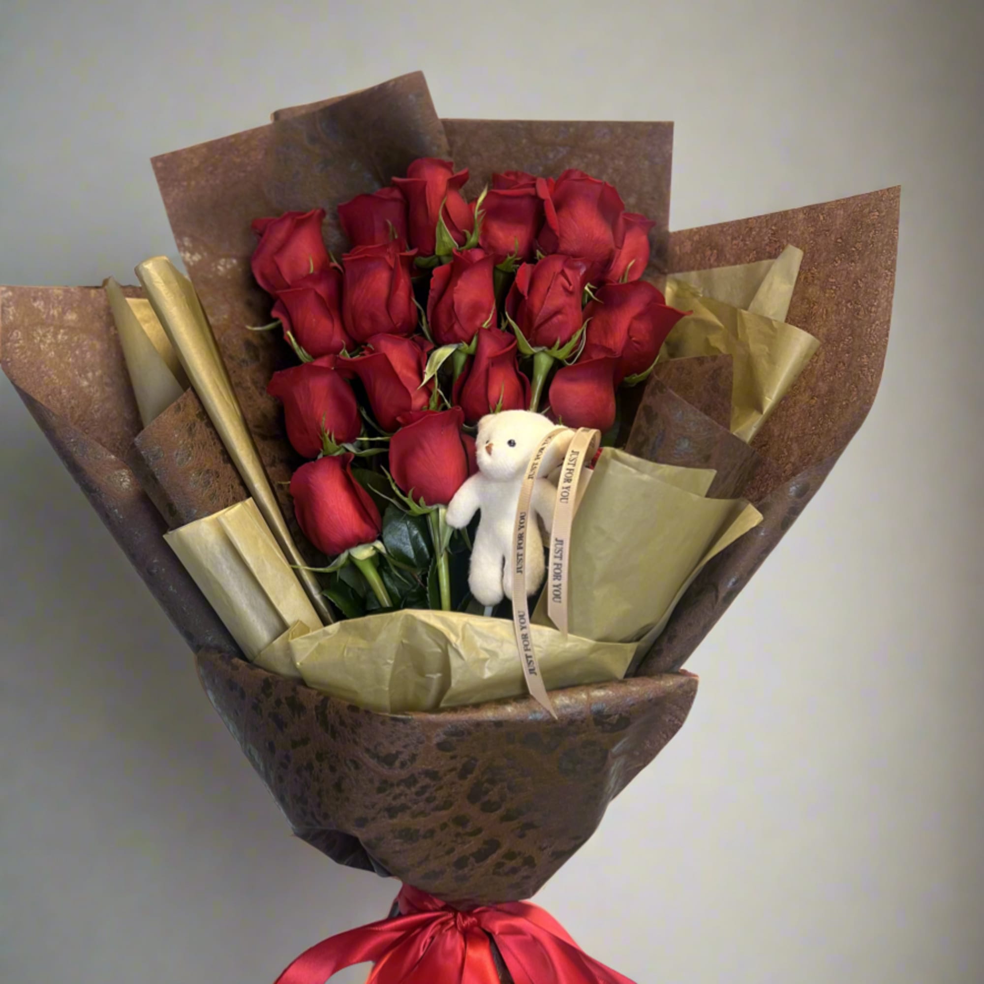 A sleek and sophisticated arrangement of premium red roses, elegantly wrapped in
