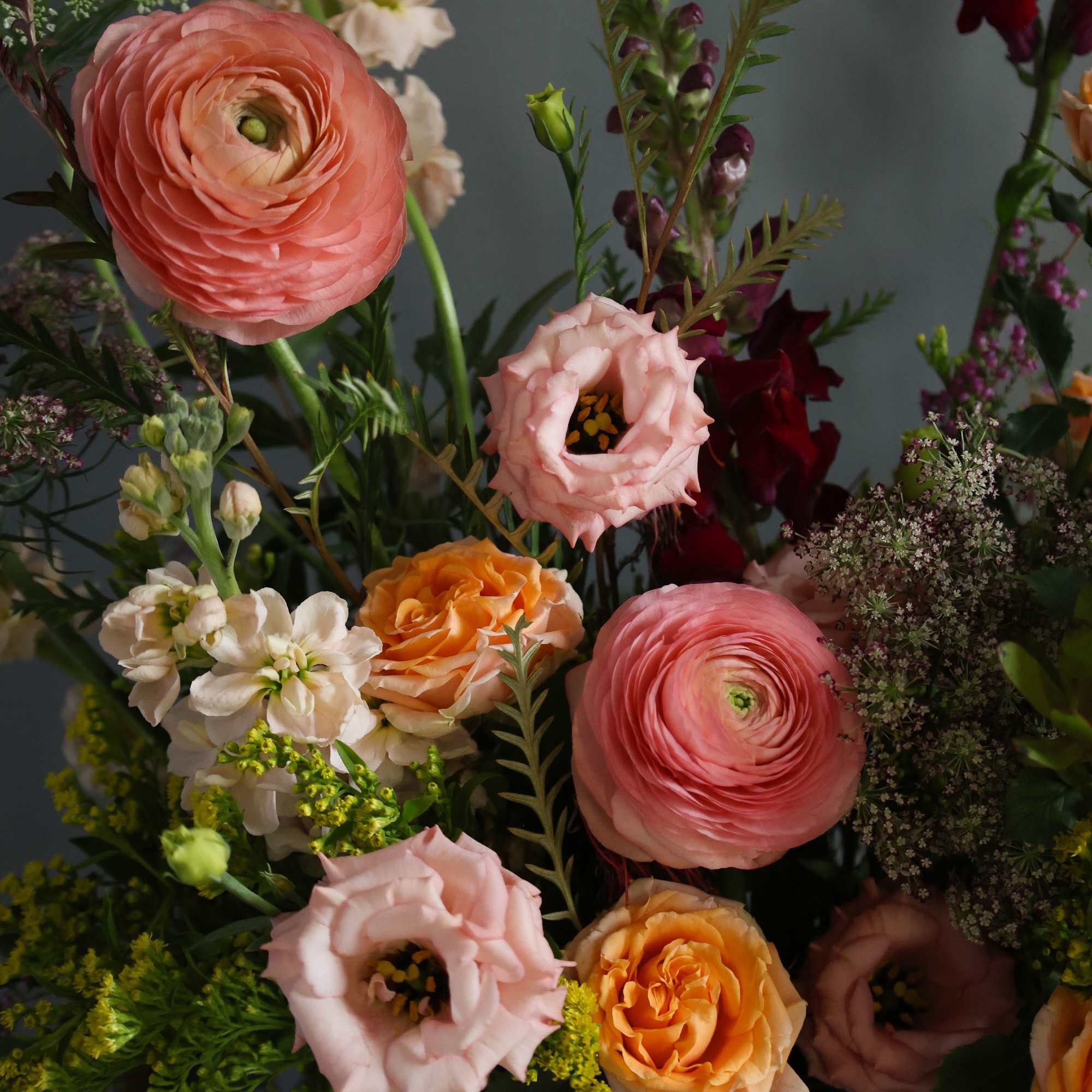 a whimsical and garden one sided arrangement in a beautiful keepsake mirror