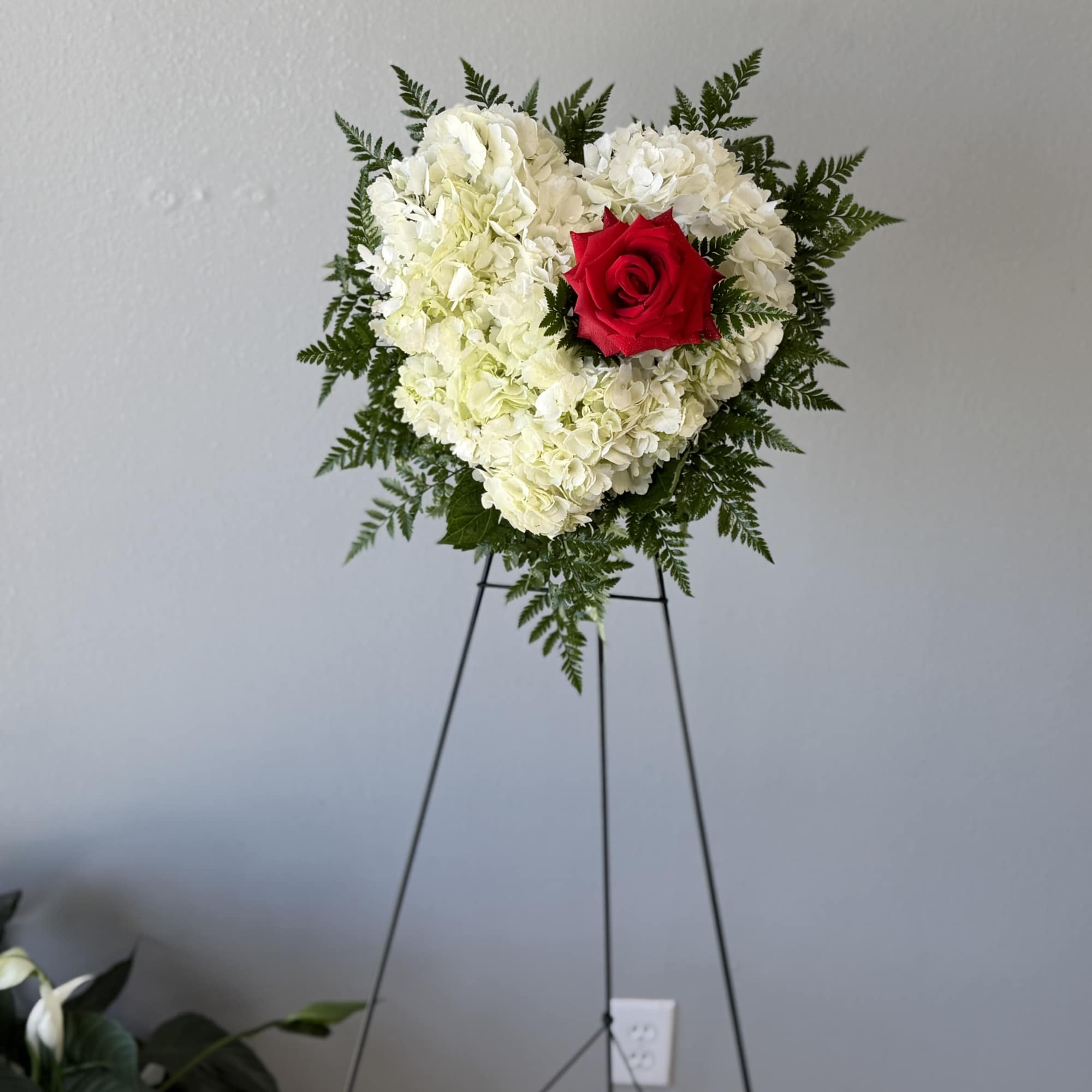 Mini heart on easel. A soft cushion of white hydrangeas shaped into