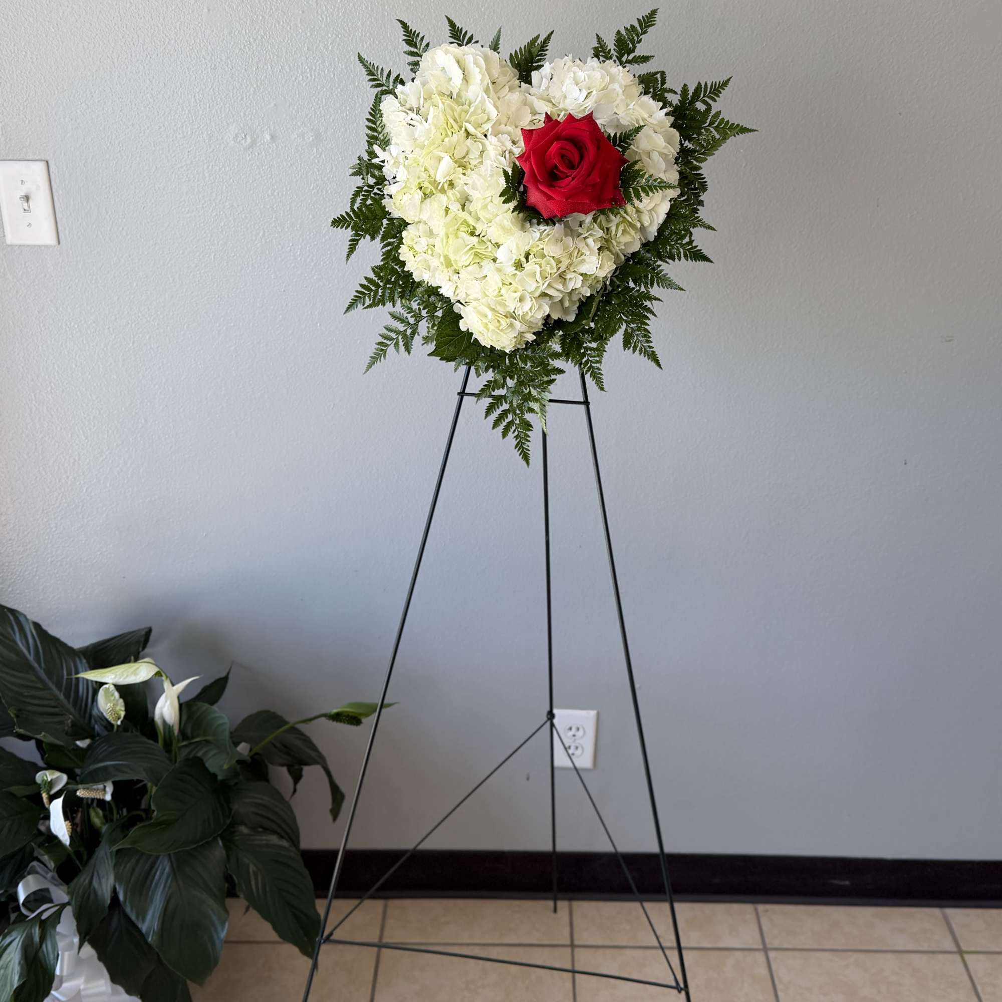 Mini heart on easel. A soft cushion of white hydrangeas shaped into
