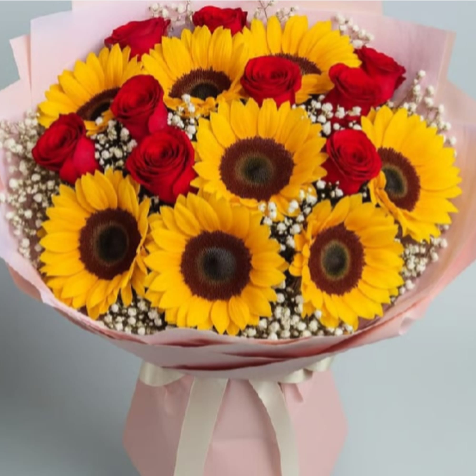 Golden sunflowers form a radiant halo in this hand-tied flower arrangement, the