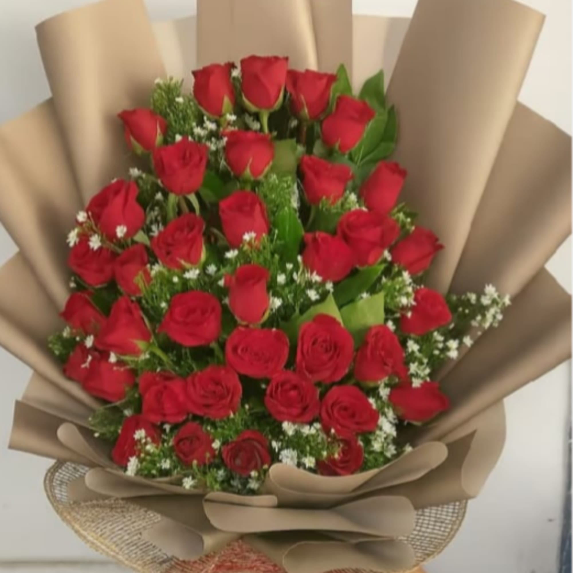 A lush dome of dozens of red roses creates an immediate, heart‑stopping