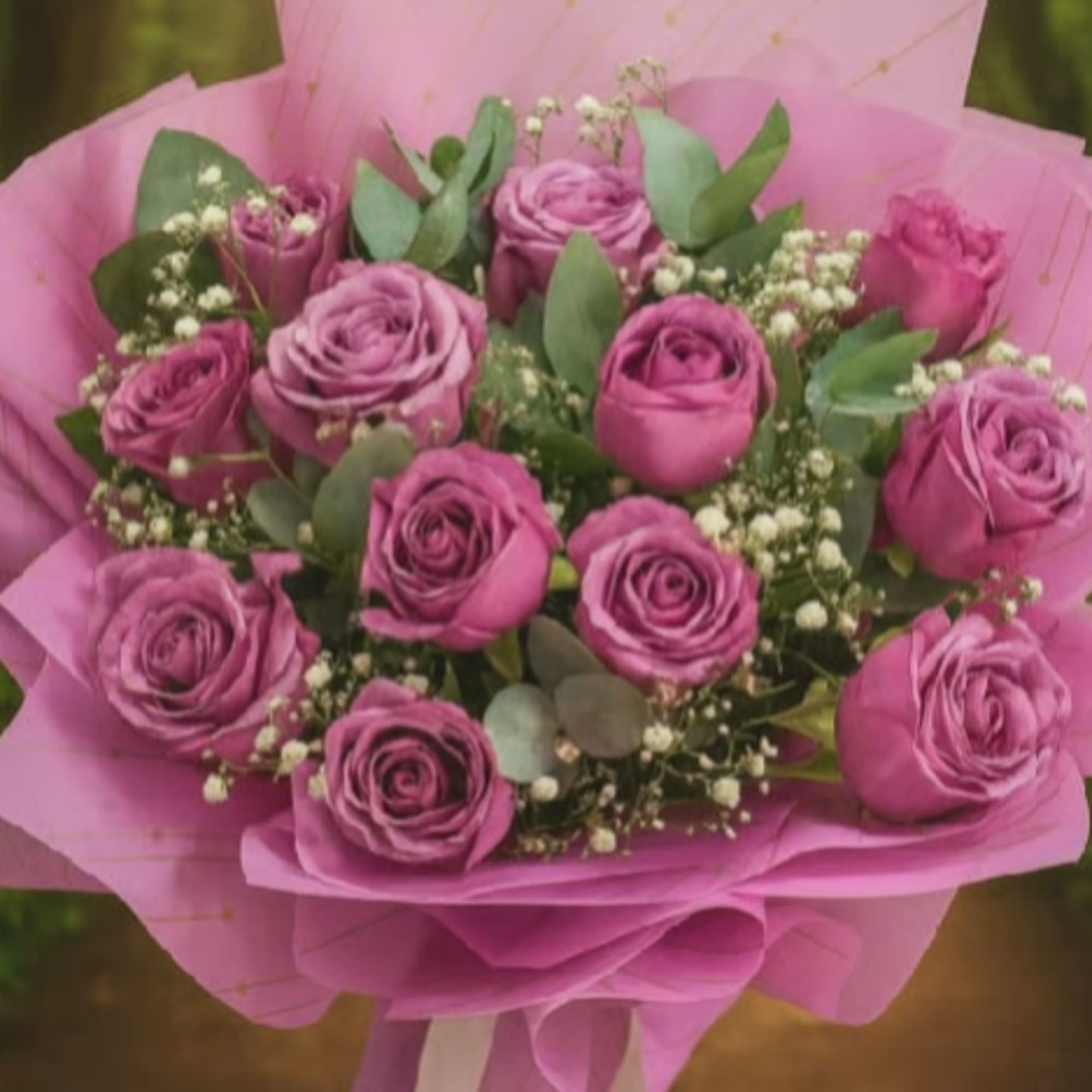 A lush cluster of mauve-pink roses creates an immediate impression of warmth