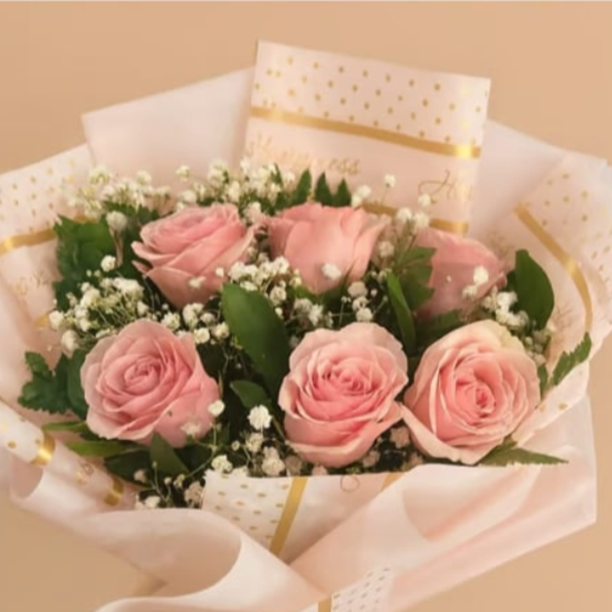 Soft pink roses gathered in a close, romantic cluster create the first