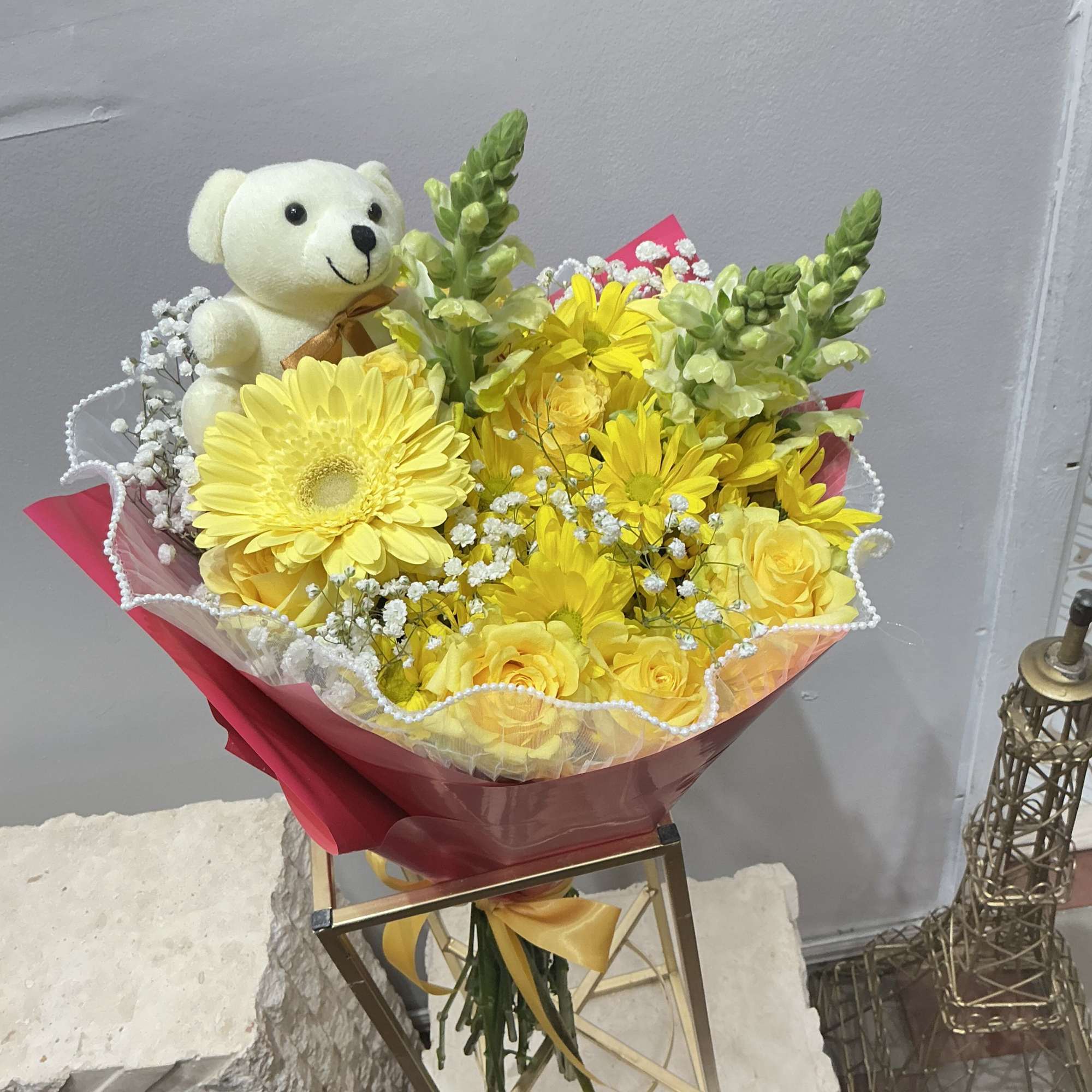 A basket brimming with our freshest daisy pompons, alstroemeria, an Asiatic lily