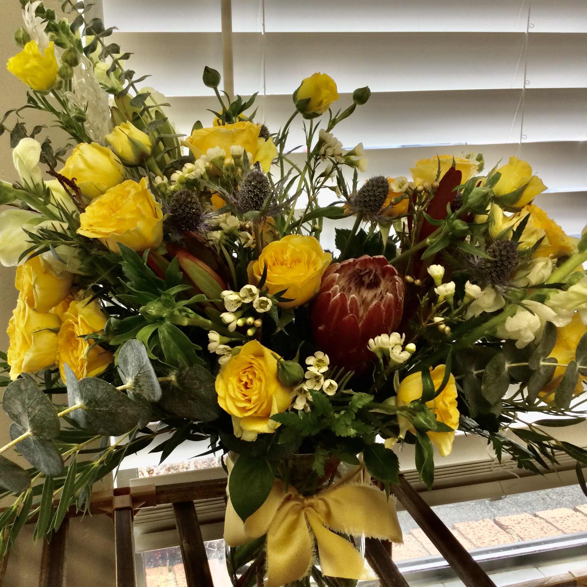Loads of Yellow Bombastic roses, yellow butterfly ranunculus, Thistle, Protea, Safari Sunset