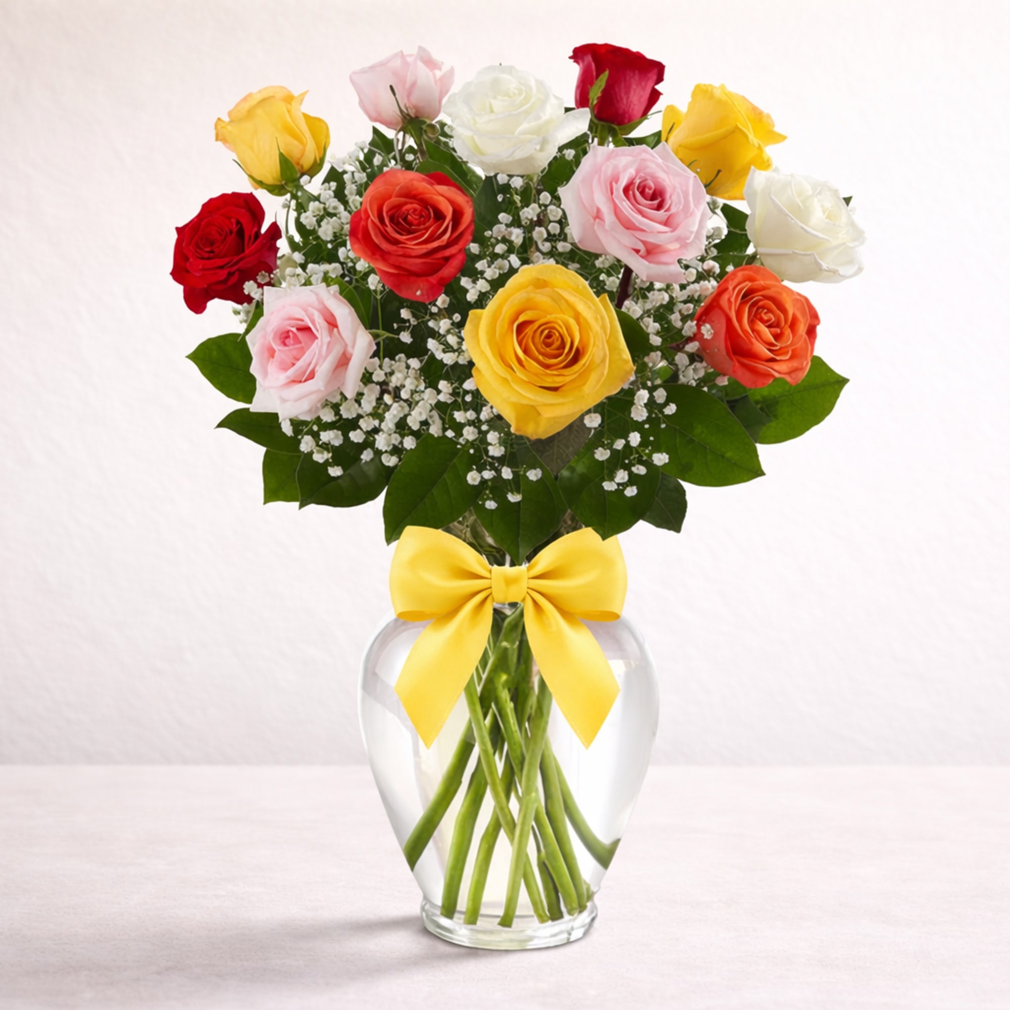Assorted color roses in a clear glass vase. Perfect for any day