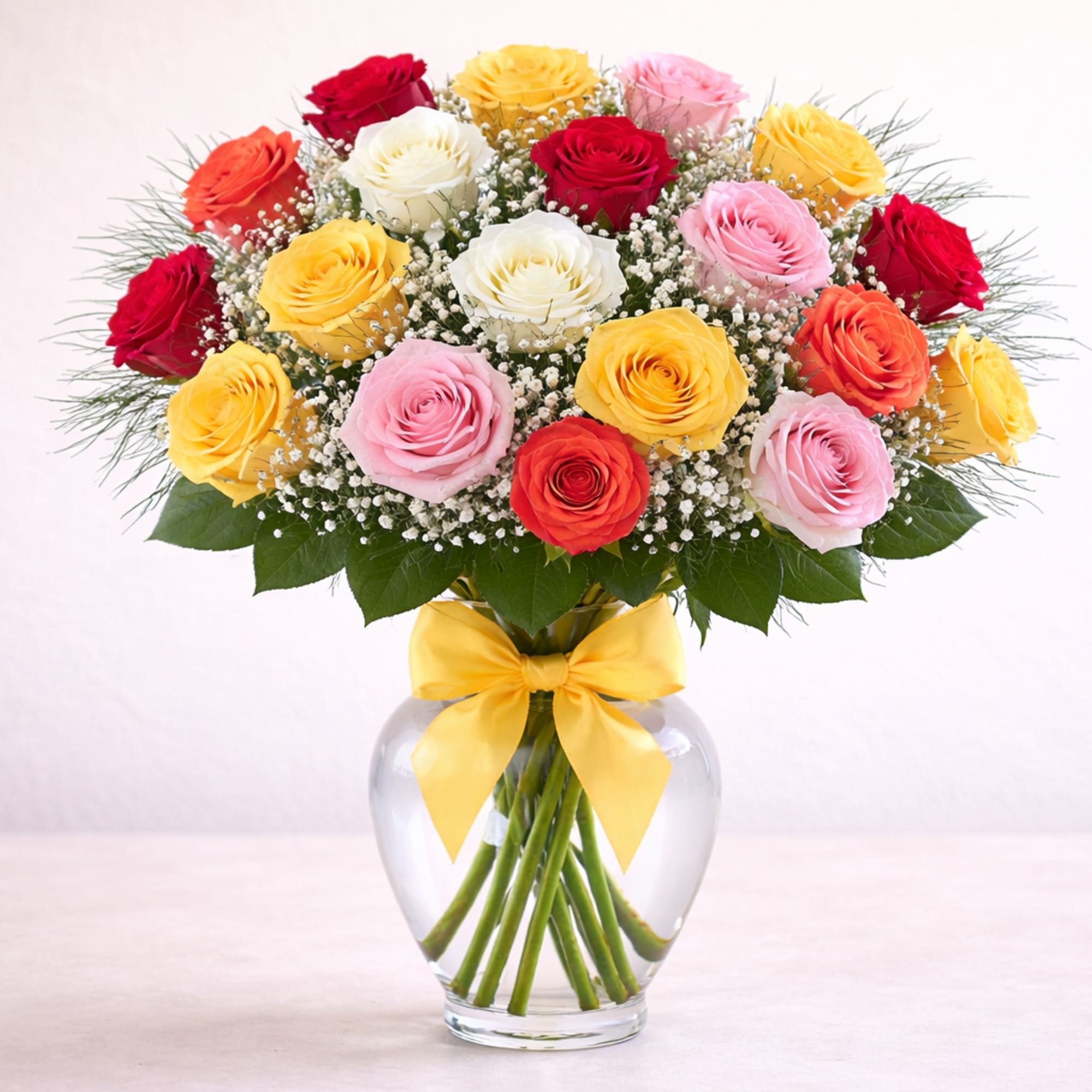 Assorted color roses in a clear glass vase. Perfect for any day