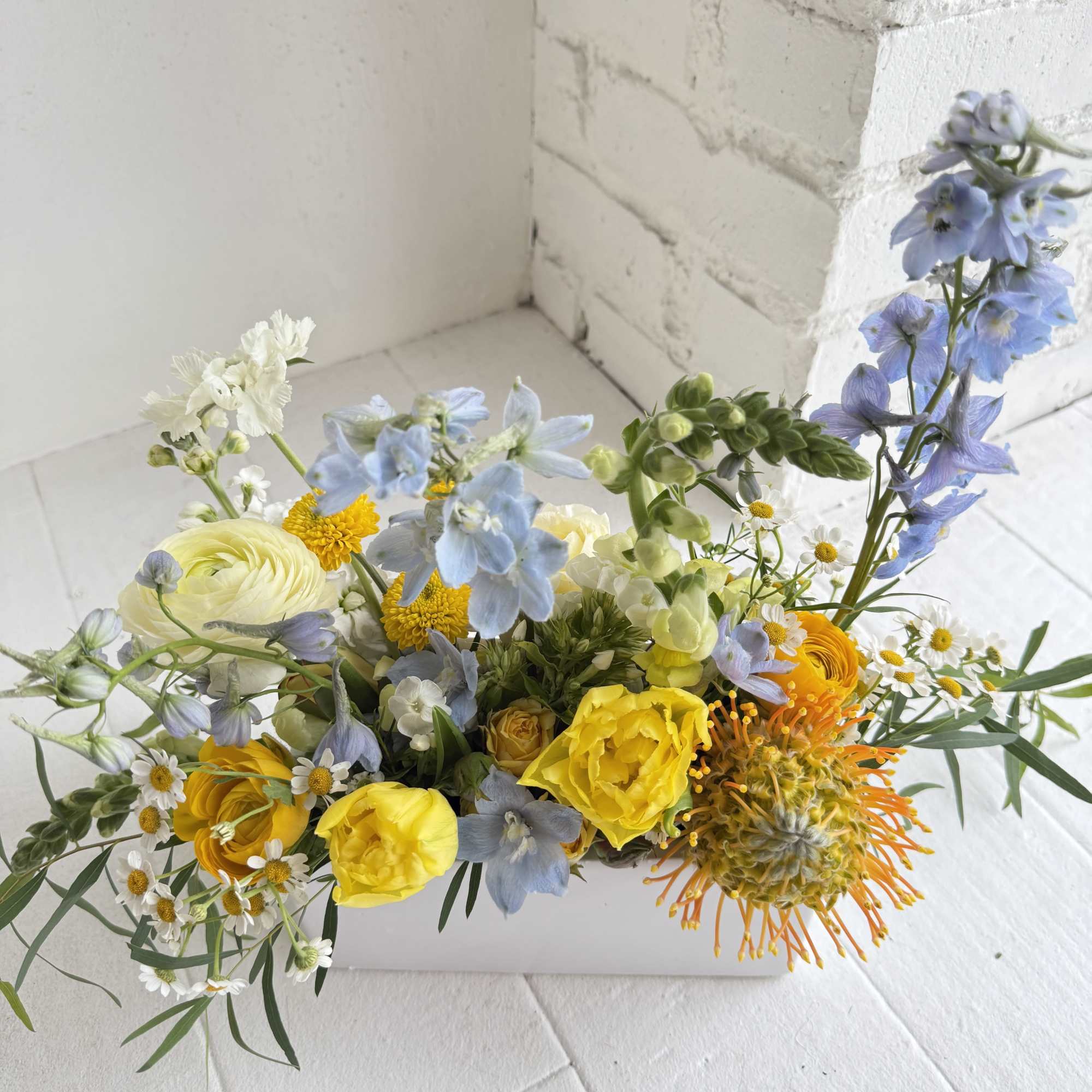 A pretty mix of blues, yellows and whites in a low, white