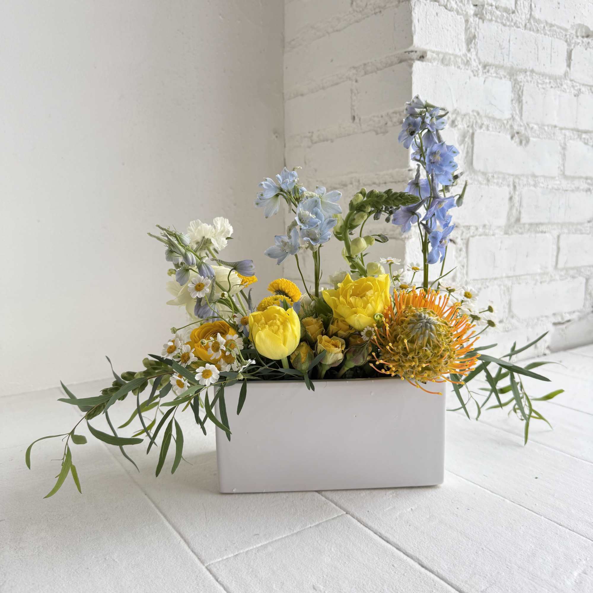 A pretty mix of blues, yellows and whites in a low, white