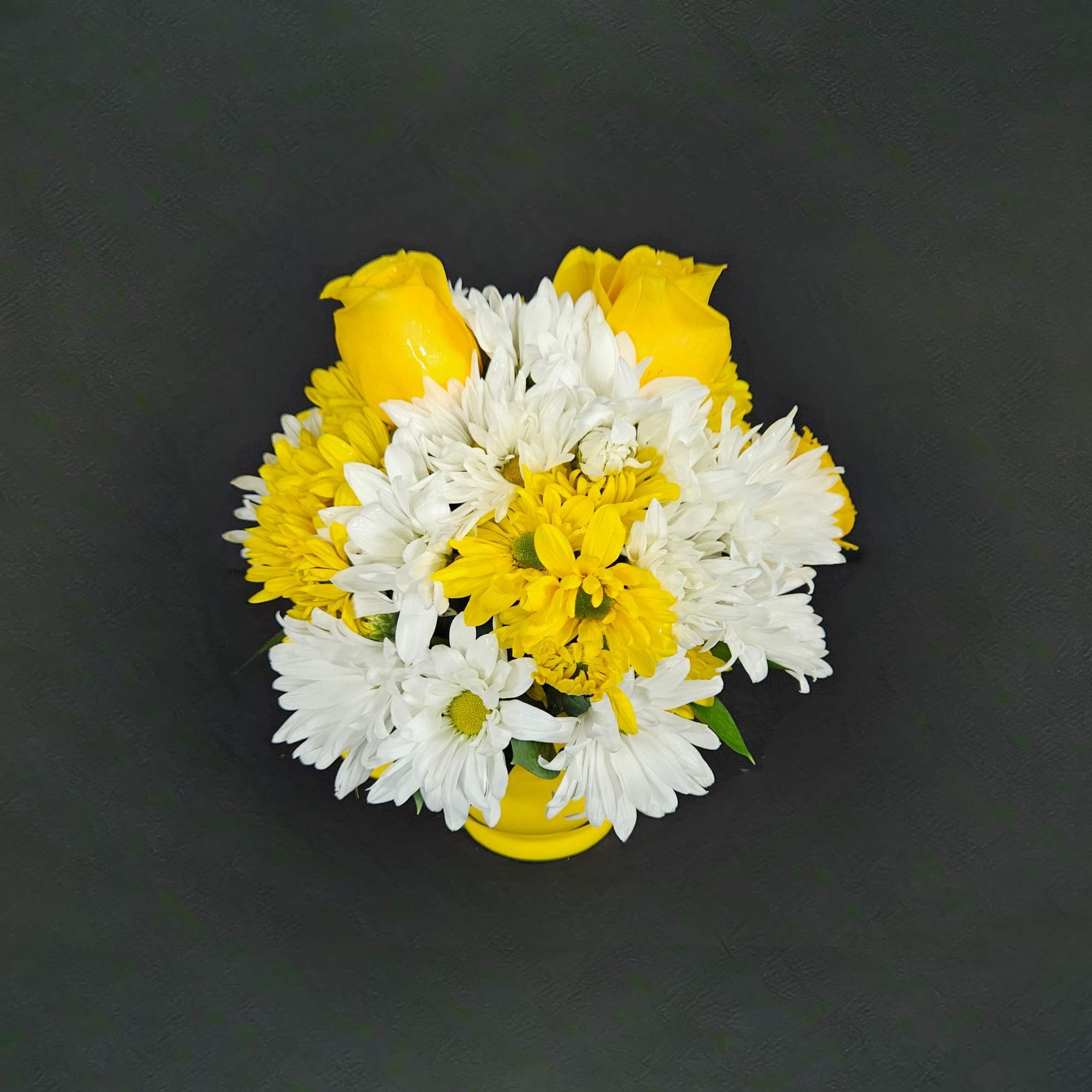 A ceramic mug happy face mug filled with bright yellow roses, white