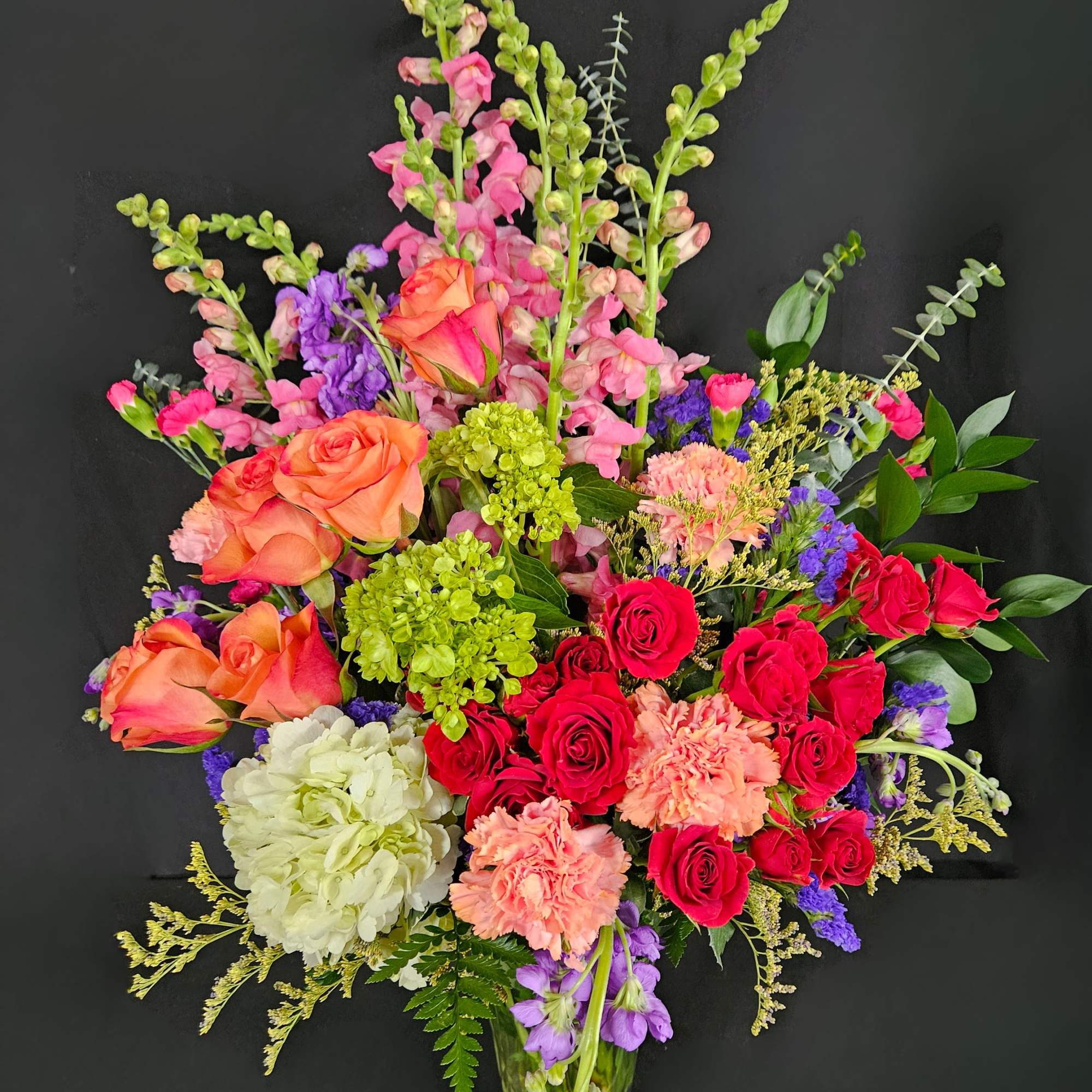 Send an arrangement as colorful and vibrant as them! With purple stock