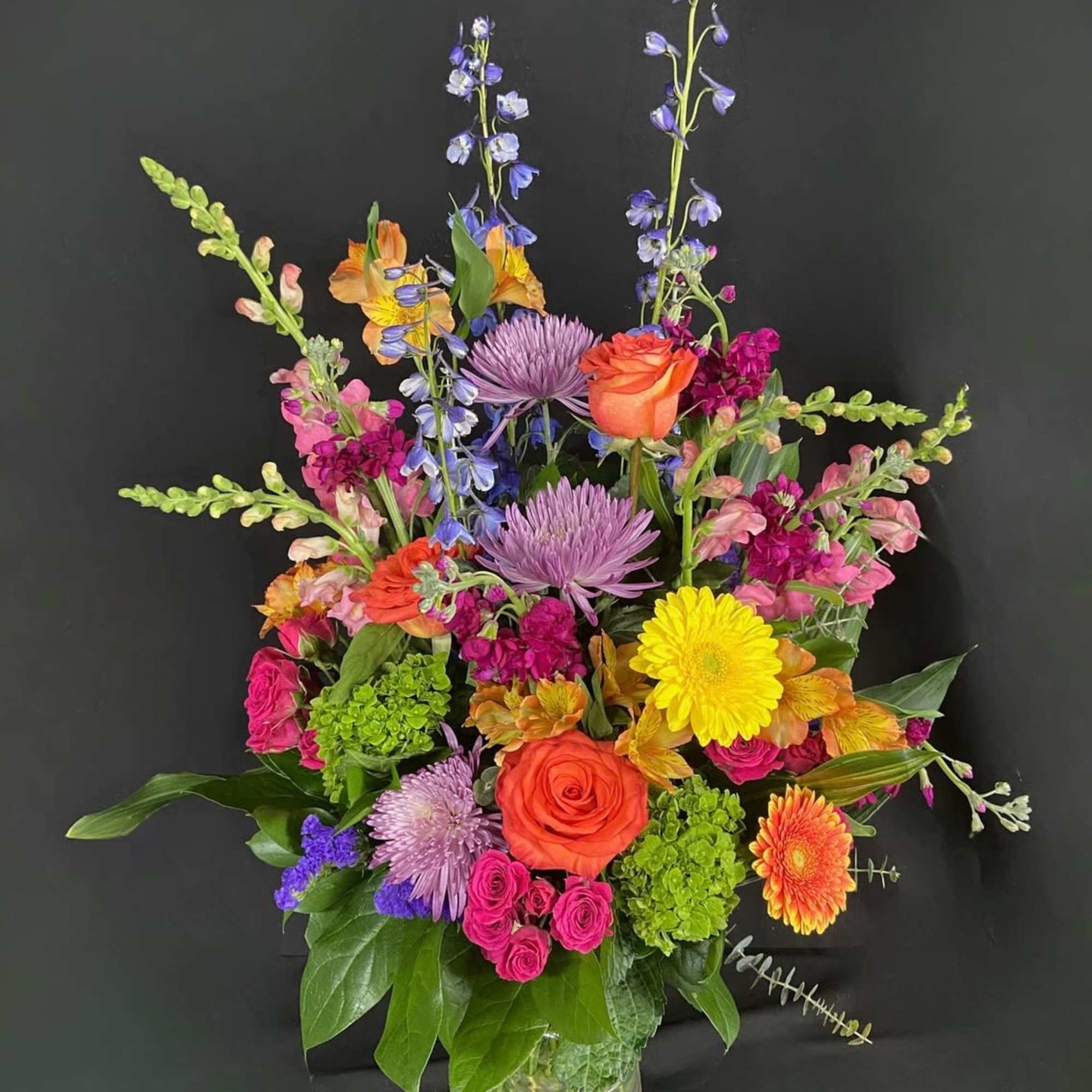 Send an arrangement as colorful and vibrant as them! With purple stock