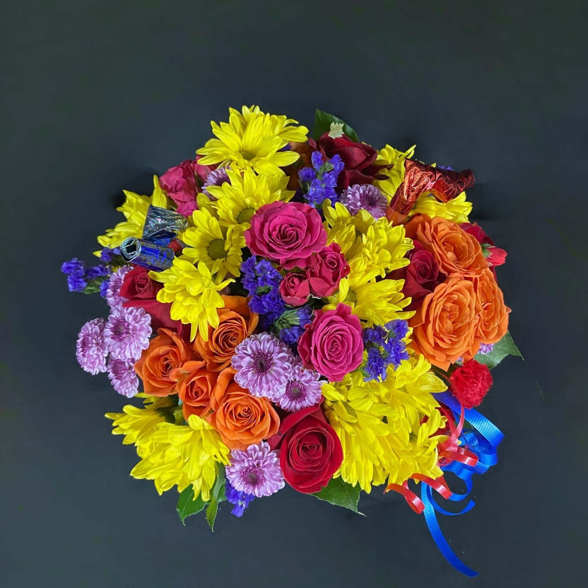 A frosted globe is decorated with birthday candles and filled with seasonal